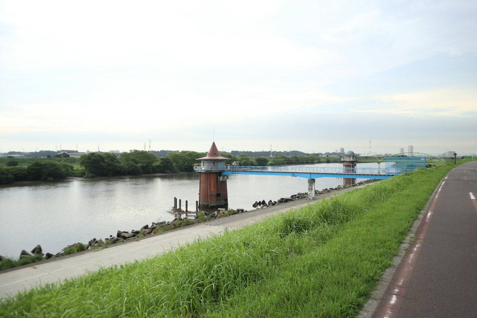 Blue bridge and red tower building by the river