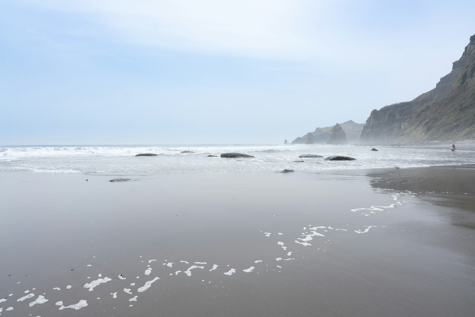 Calm beach scene with gentle waves and sandy shore