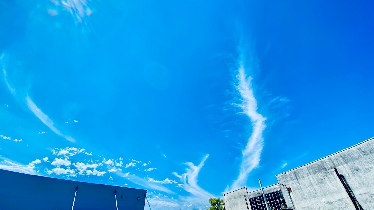 Vibrant blue sky with wispy white clouds