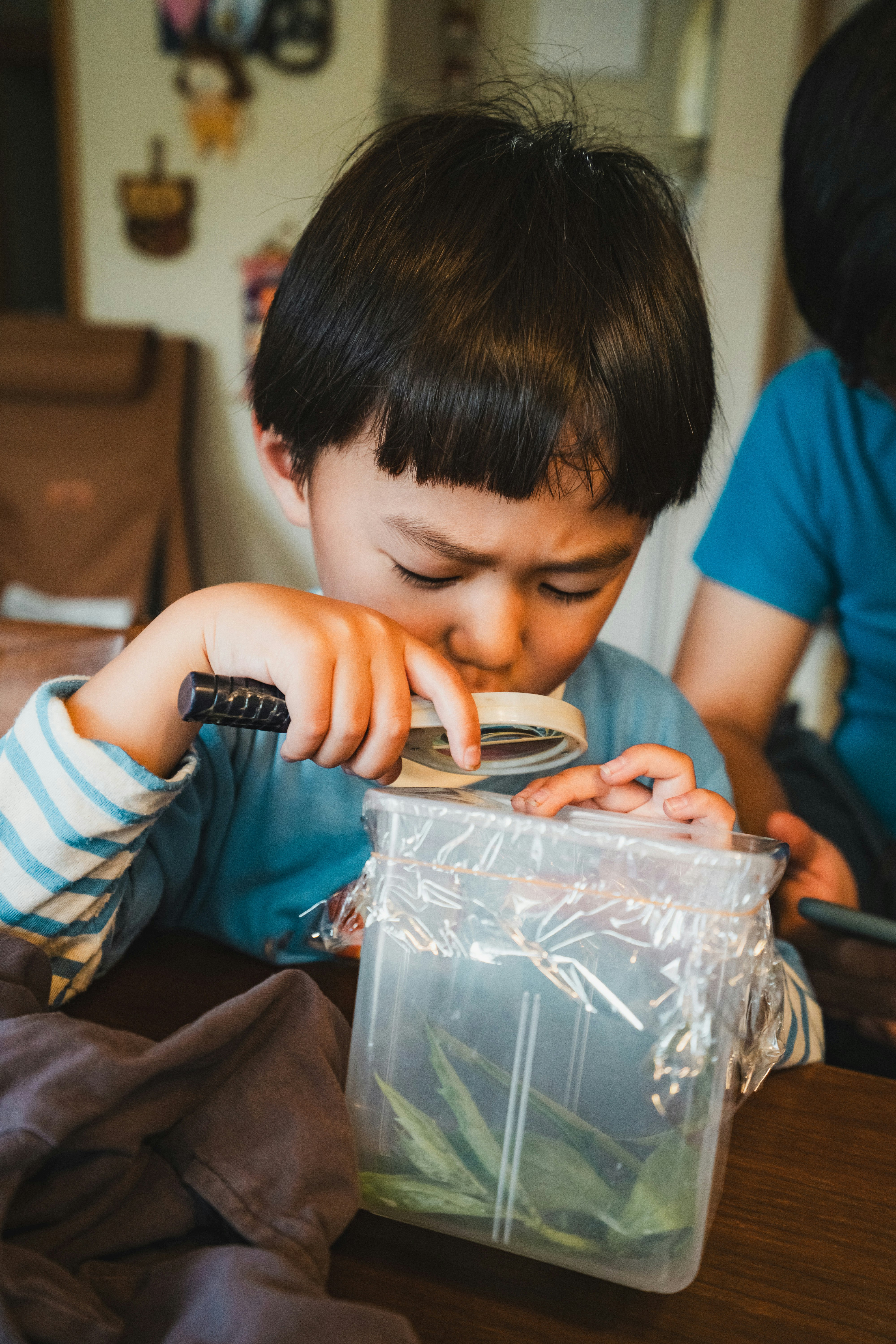 child opening a clear plastic bag with a smile