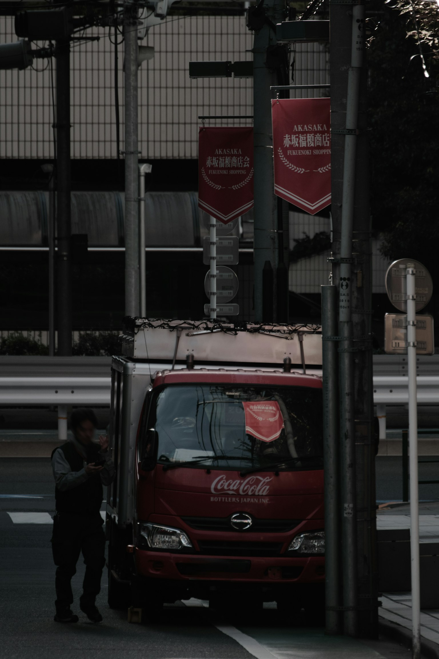 Red Coca-Cola truck parked at a street corner