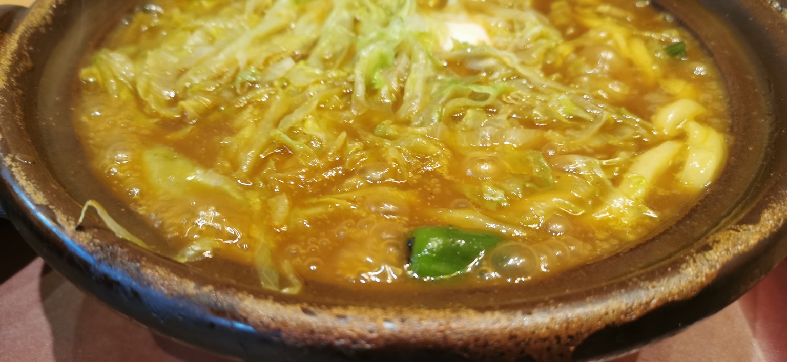 Hot pot filled with vegetables and broth