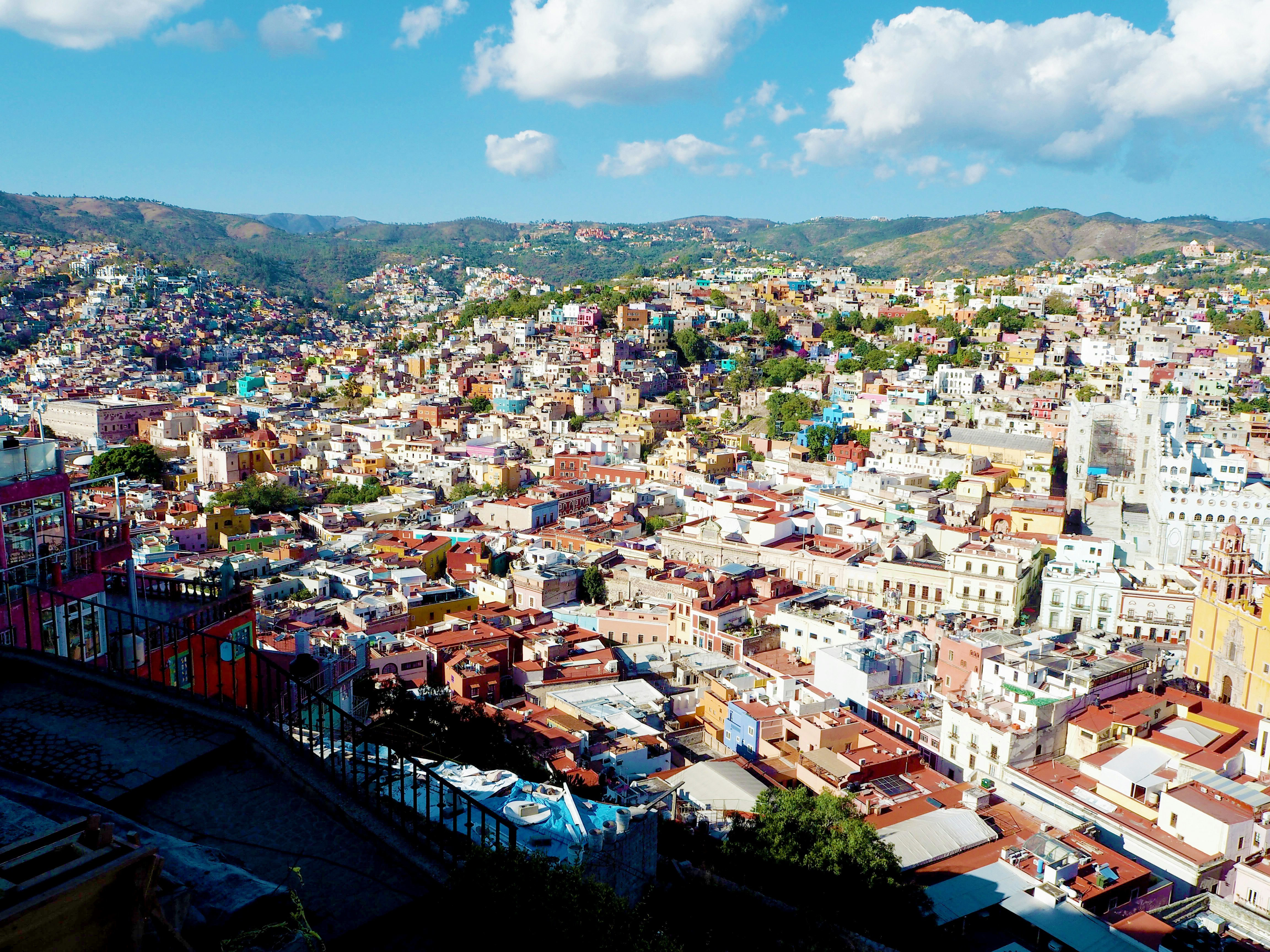 Colorful houses in the cityscape of Guanajuato under a blue sky