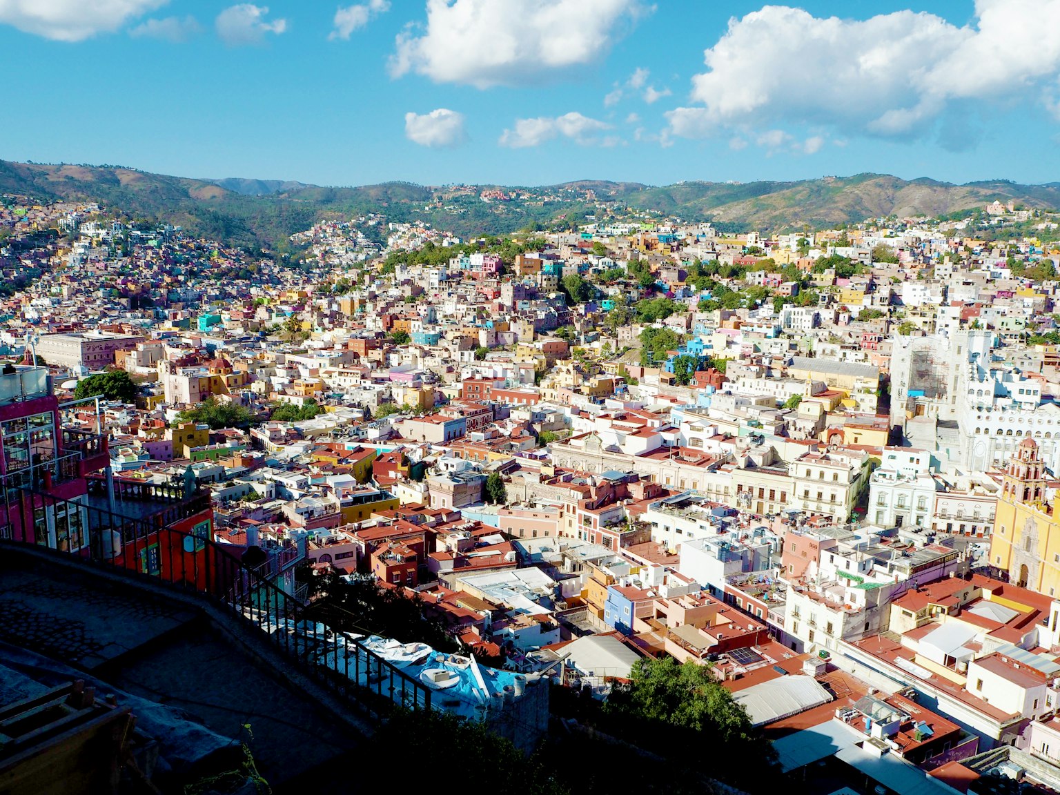 Casas coloridas en el paisaje urbano de Guanajuato bajo un cielo azul