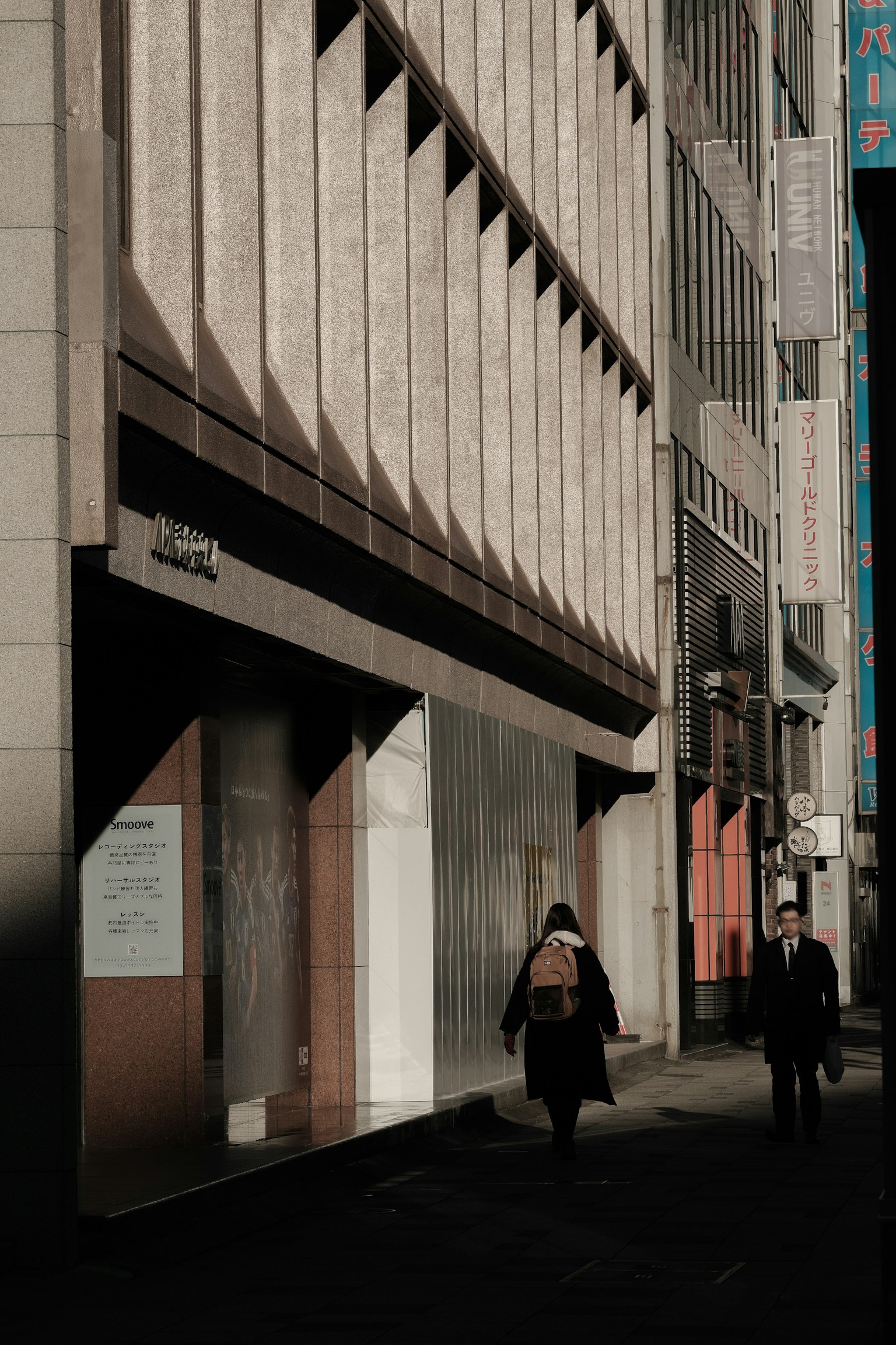 Urban street scene with a building facade and pedestrians