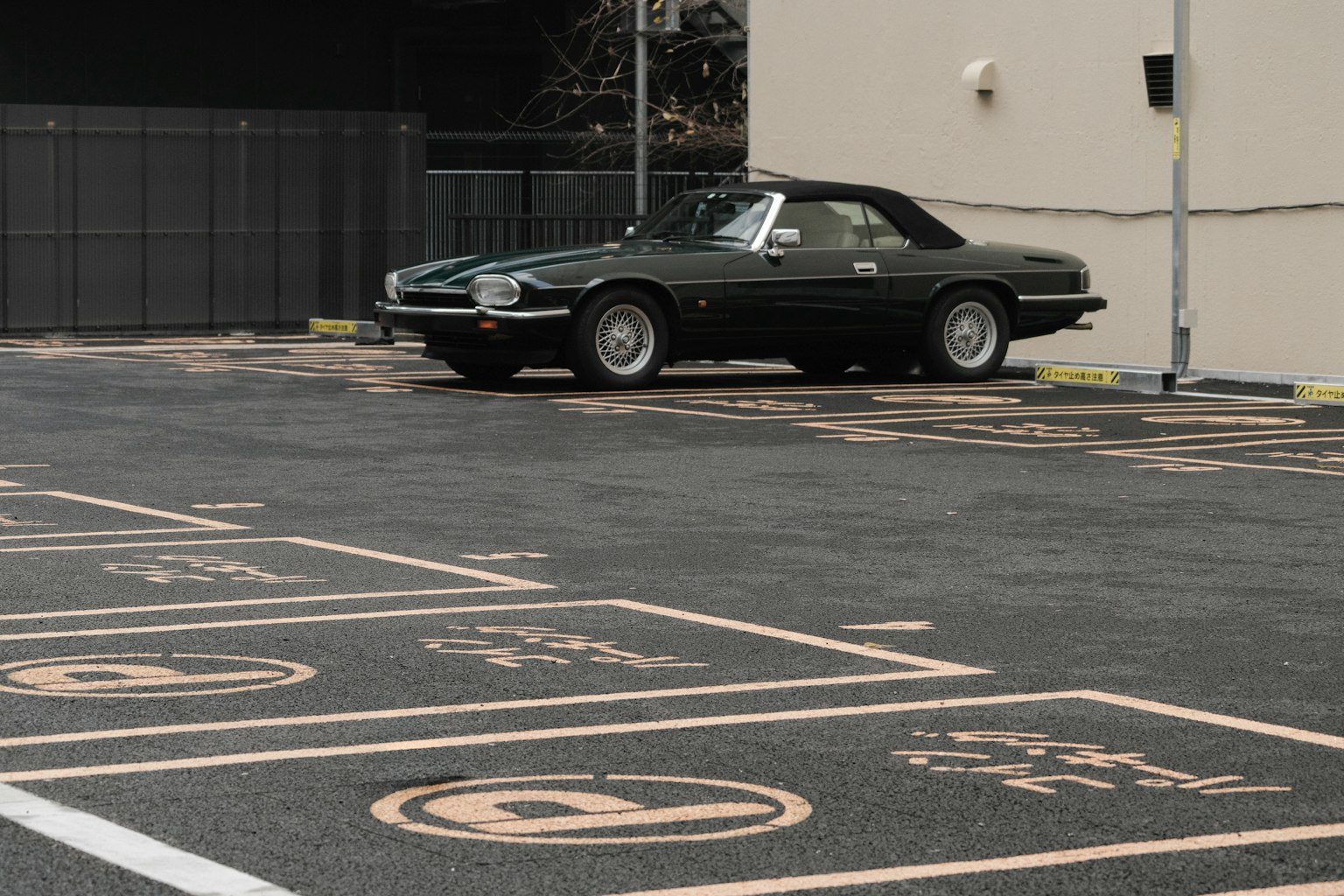 Classic green convertible car parked in a lot