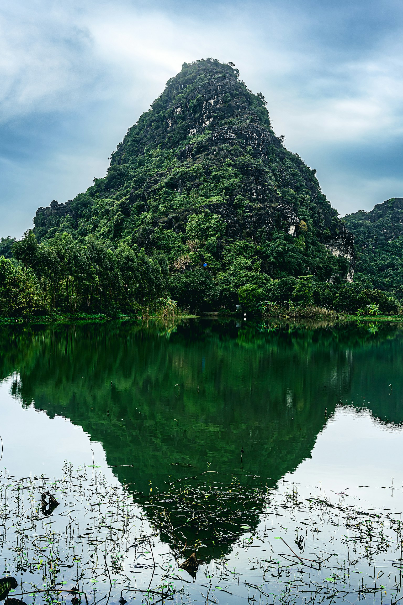 Scenic view of a green mountain reflected in a tranquil lake