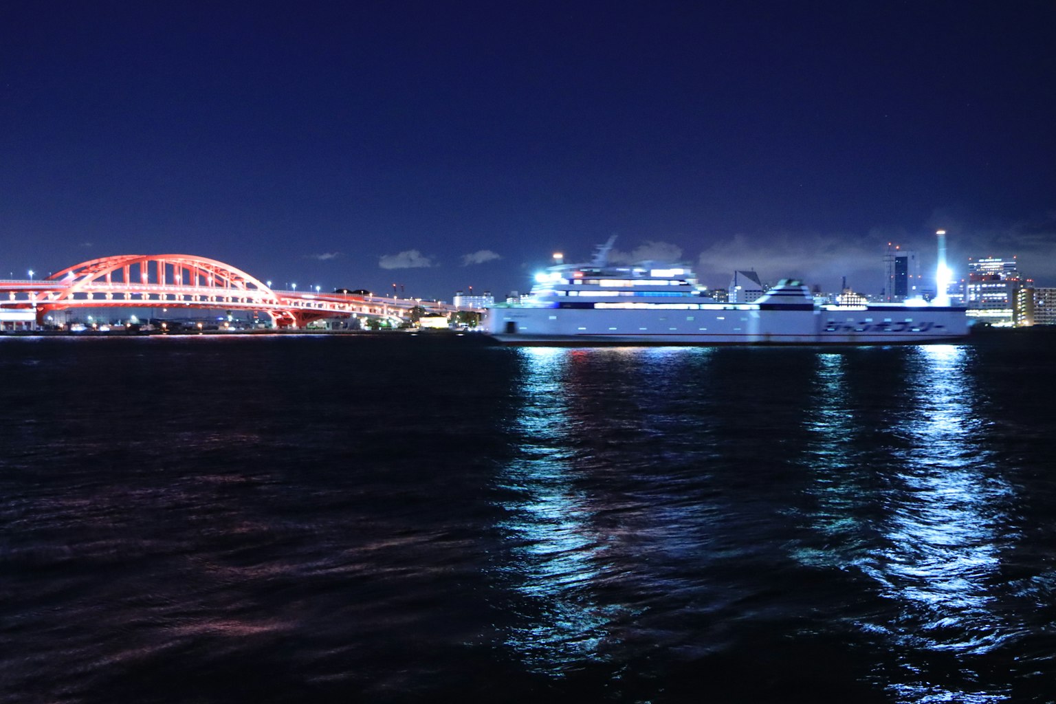 水面上的船和明亮橋樑的夜景