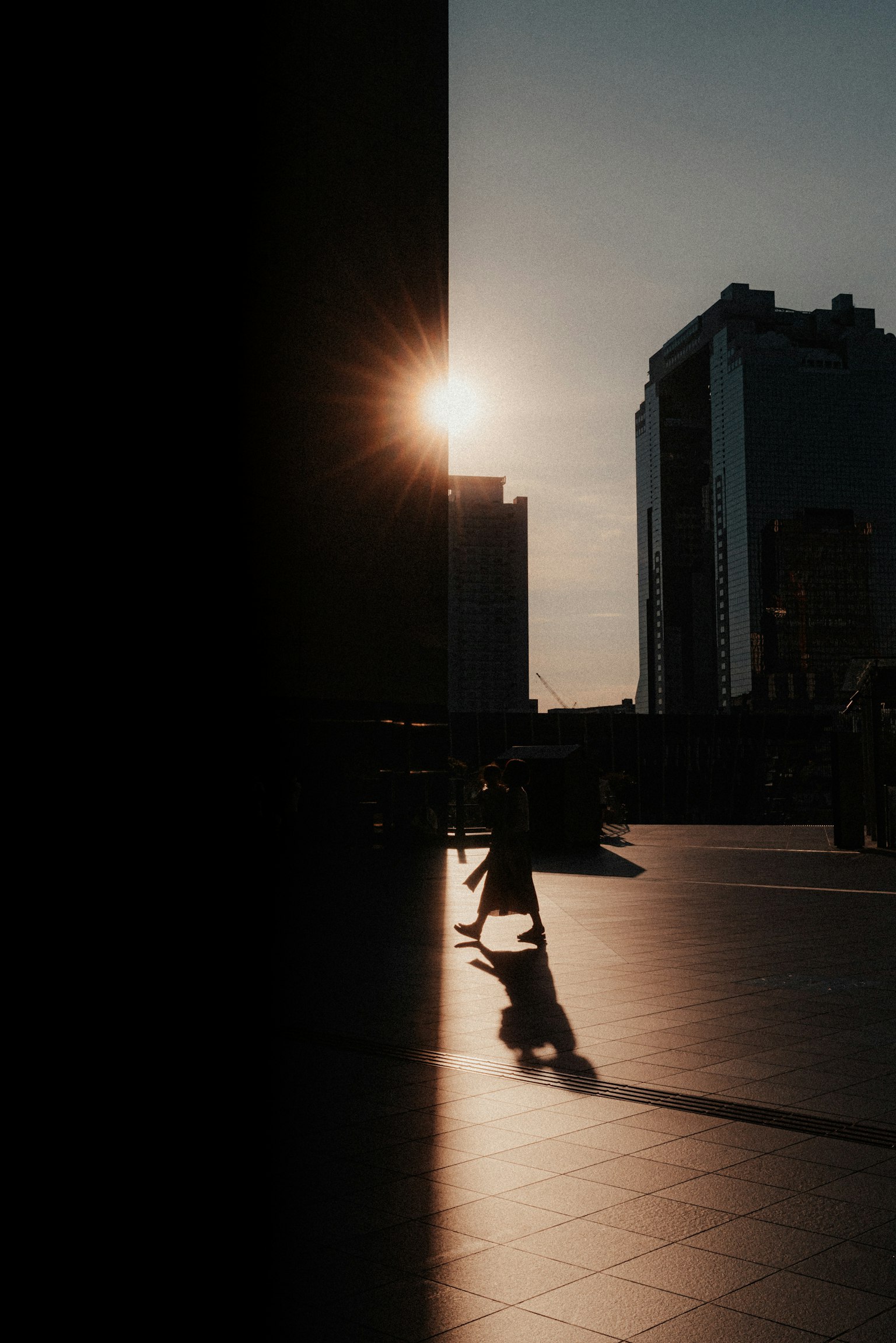 Silhouette of buildings with the sun setting in the background