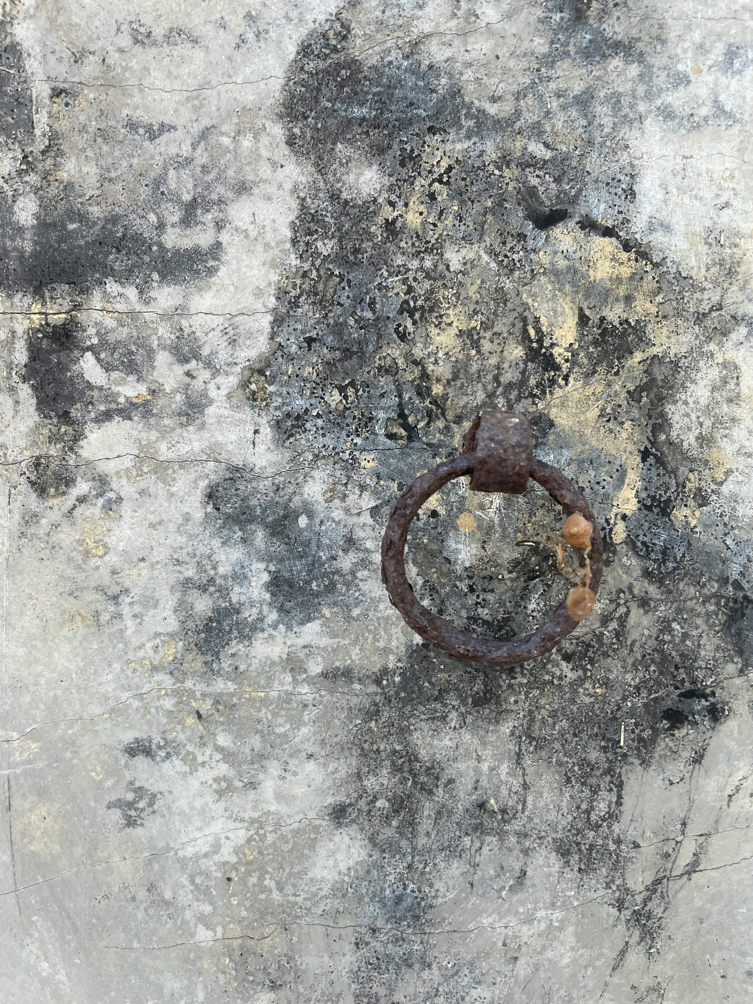 aro metálico oxidado sobre un muro de hormigón
