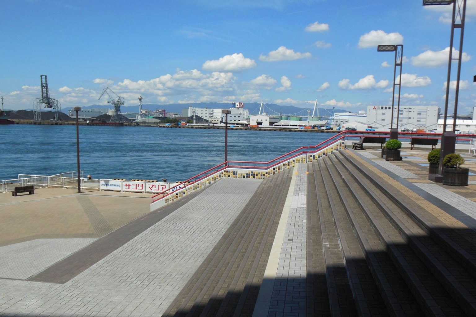 Stairs and walkway with a view of the sea and port
