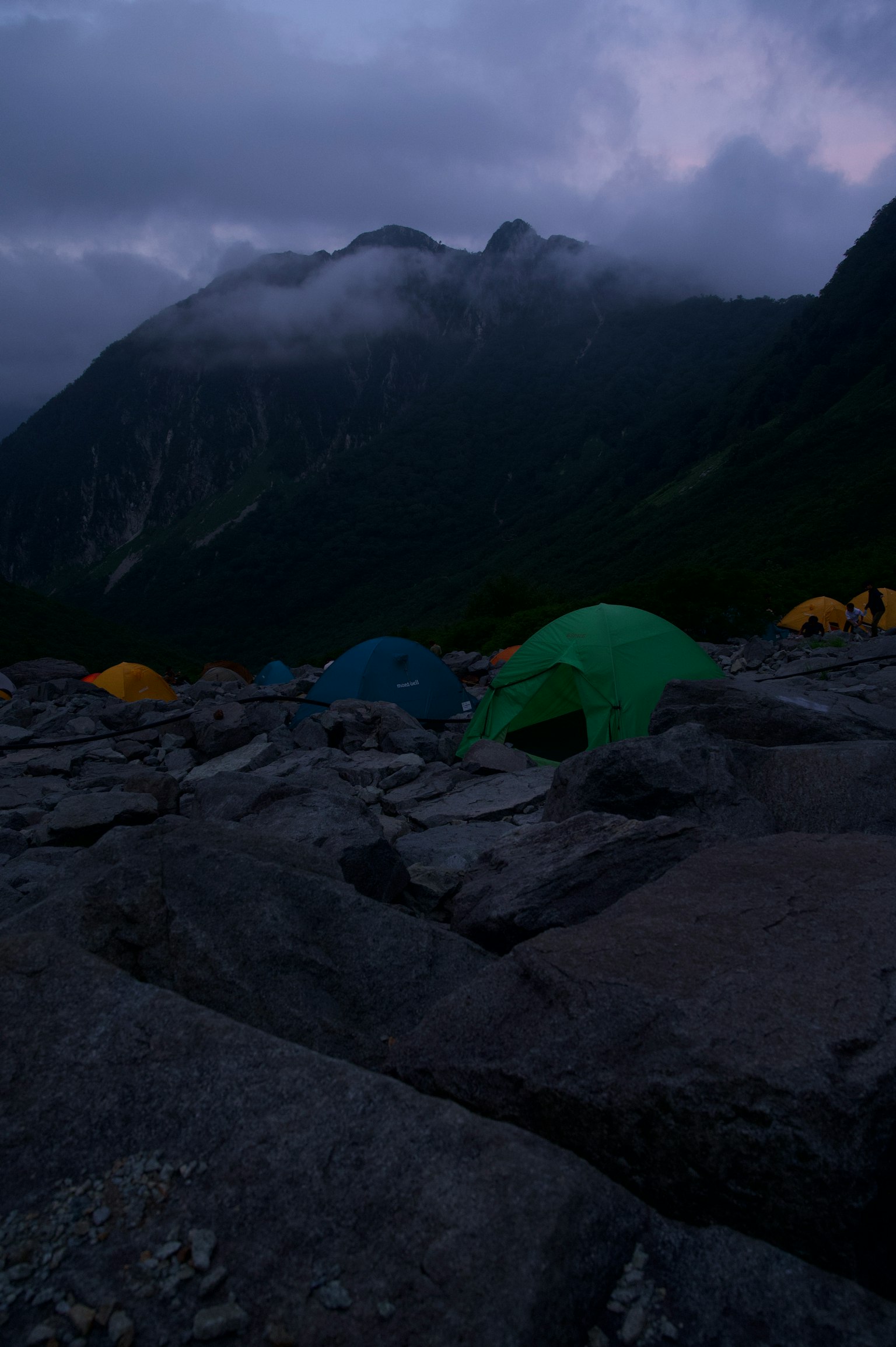 Camping mit Zelten in einer dunklen Berglandschaft