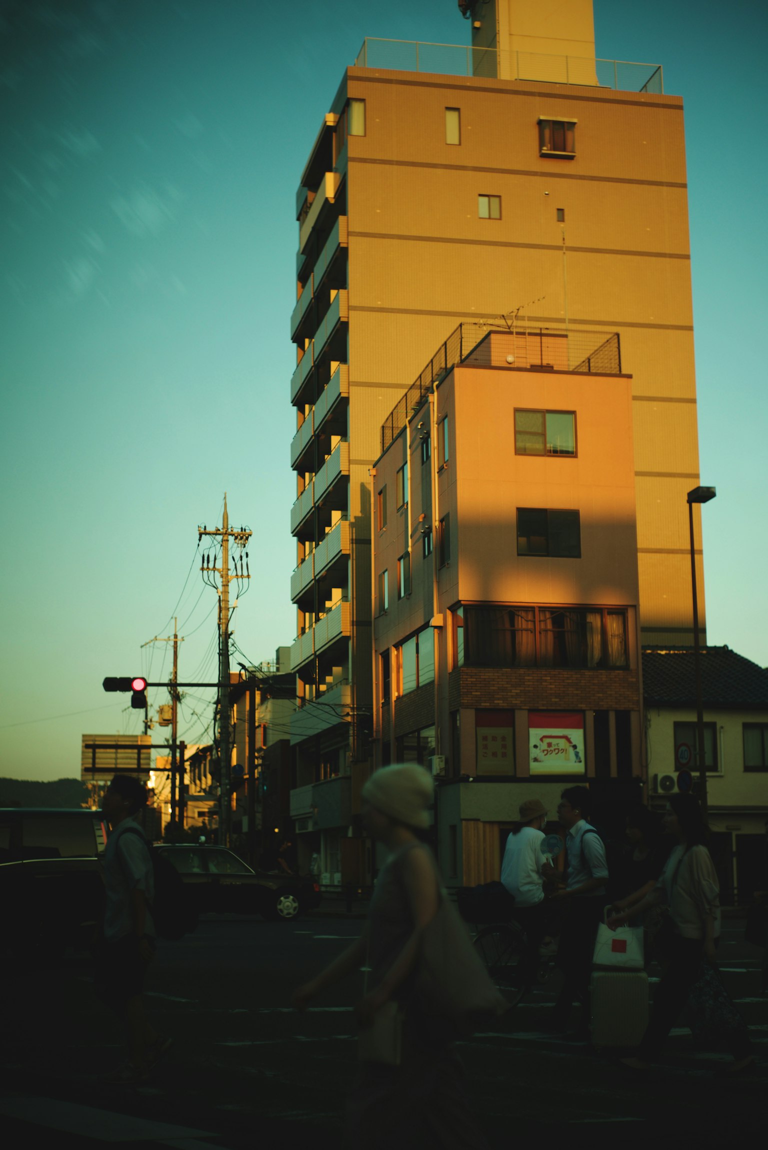 Urban scene featuring a tall building during sunset