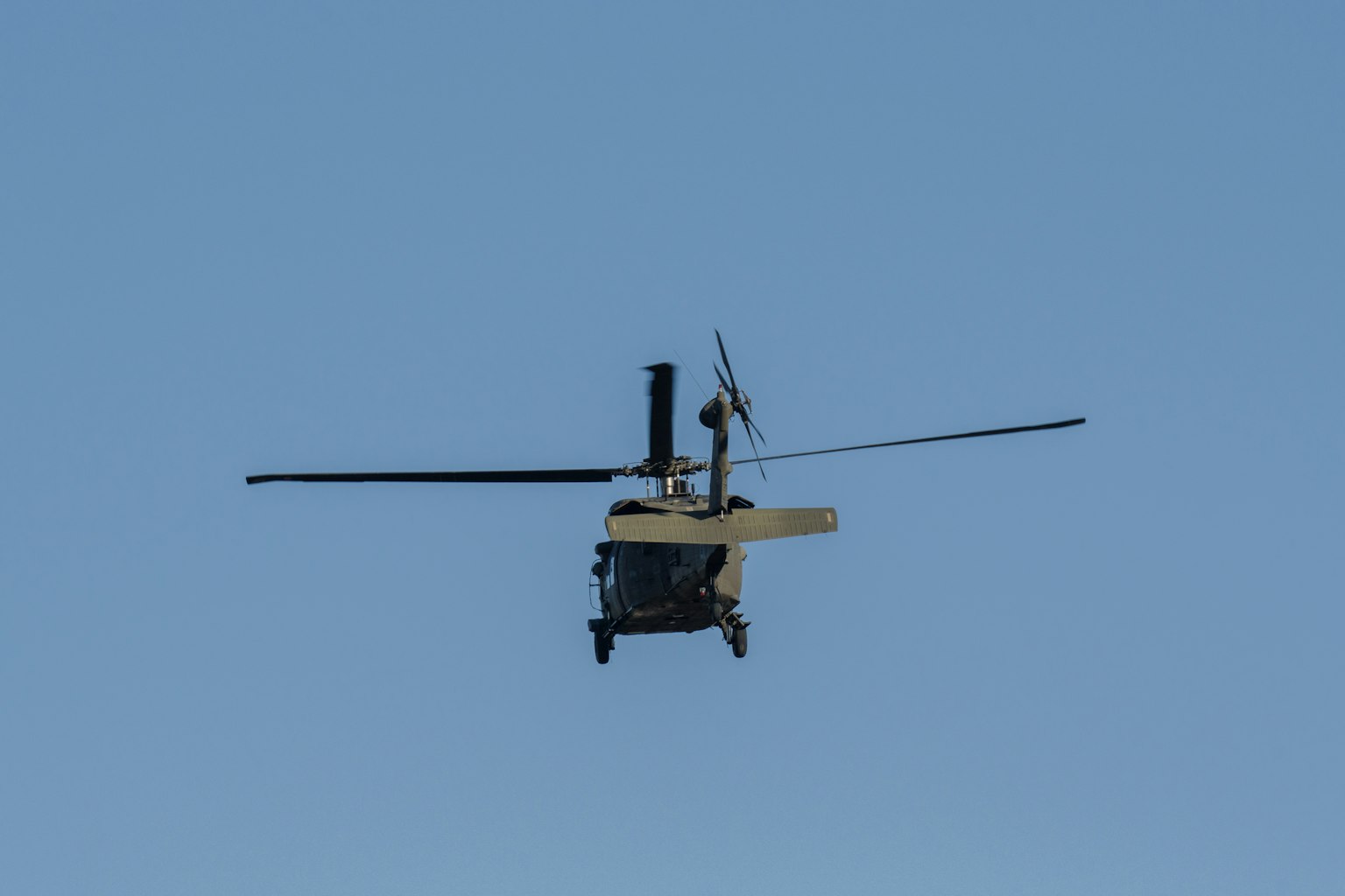 Helicopter flying against a blue sky