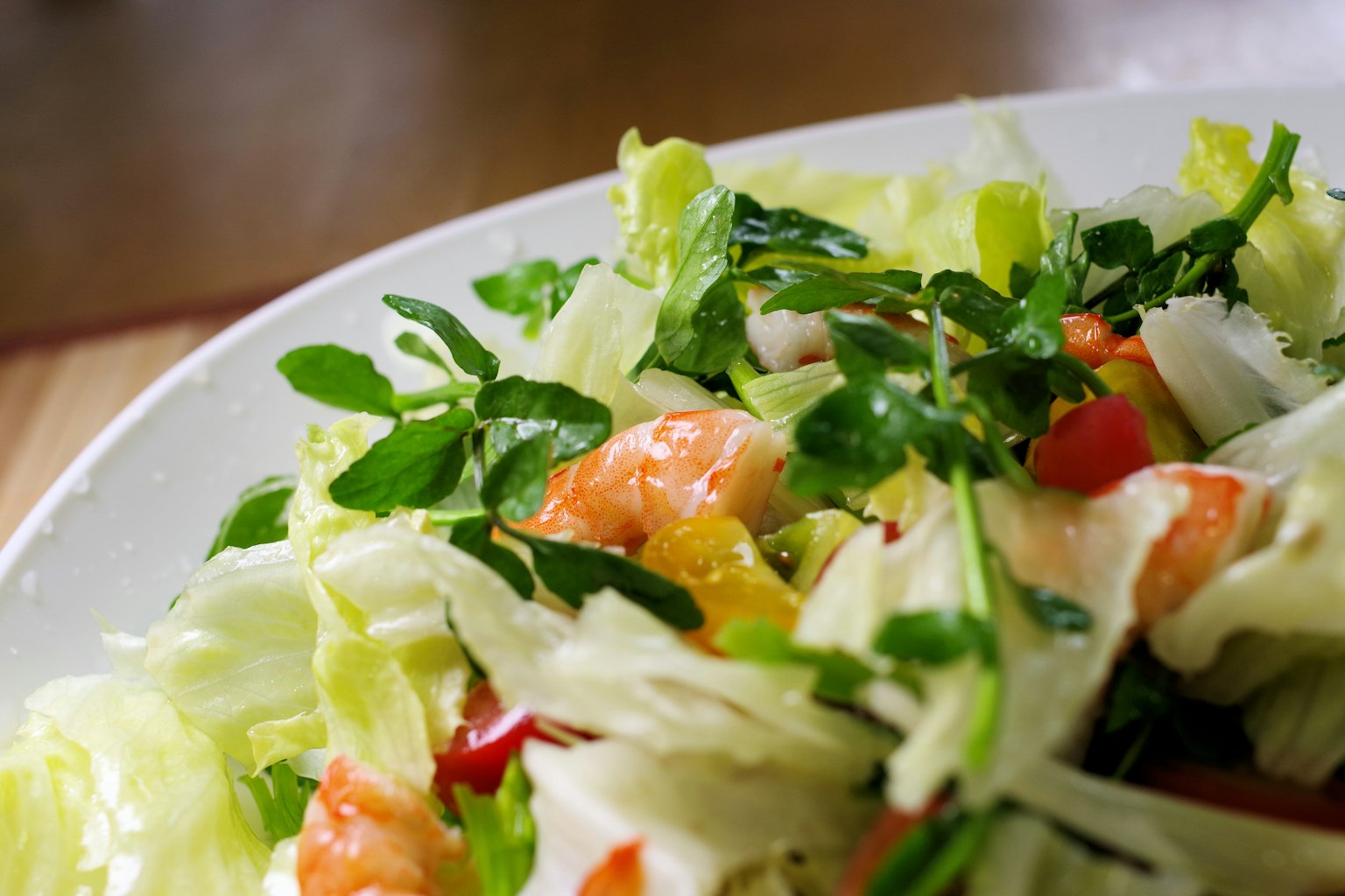Fresh vegetable and shrimp salad served on a plate
