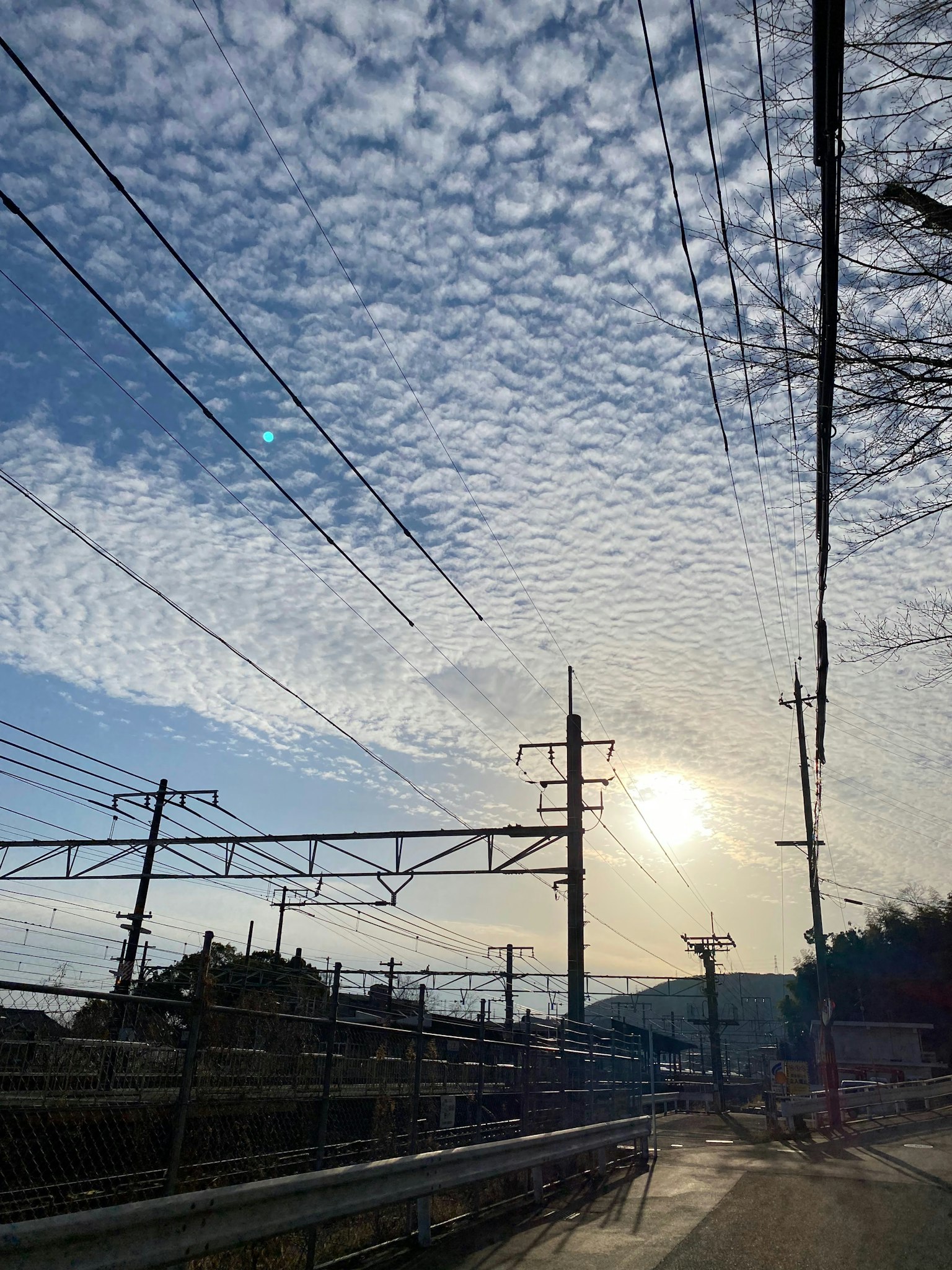 Pemandangan langit biru dengan awan dan jalur kereta api di atas