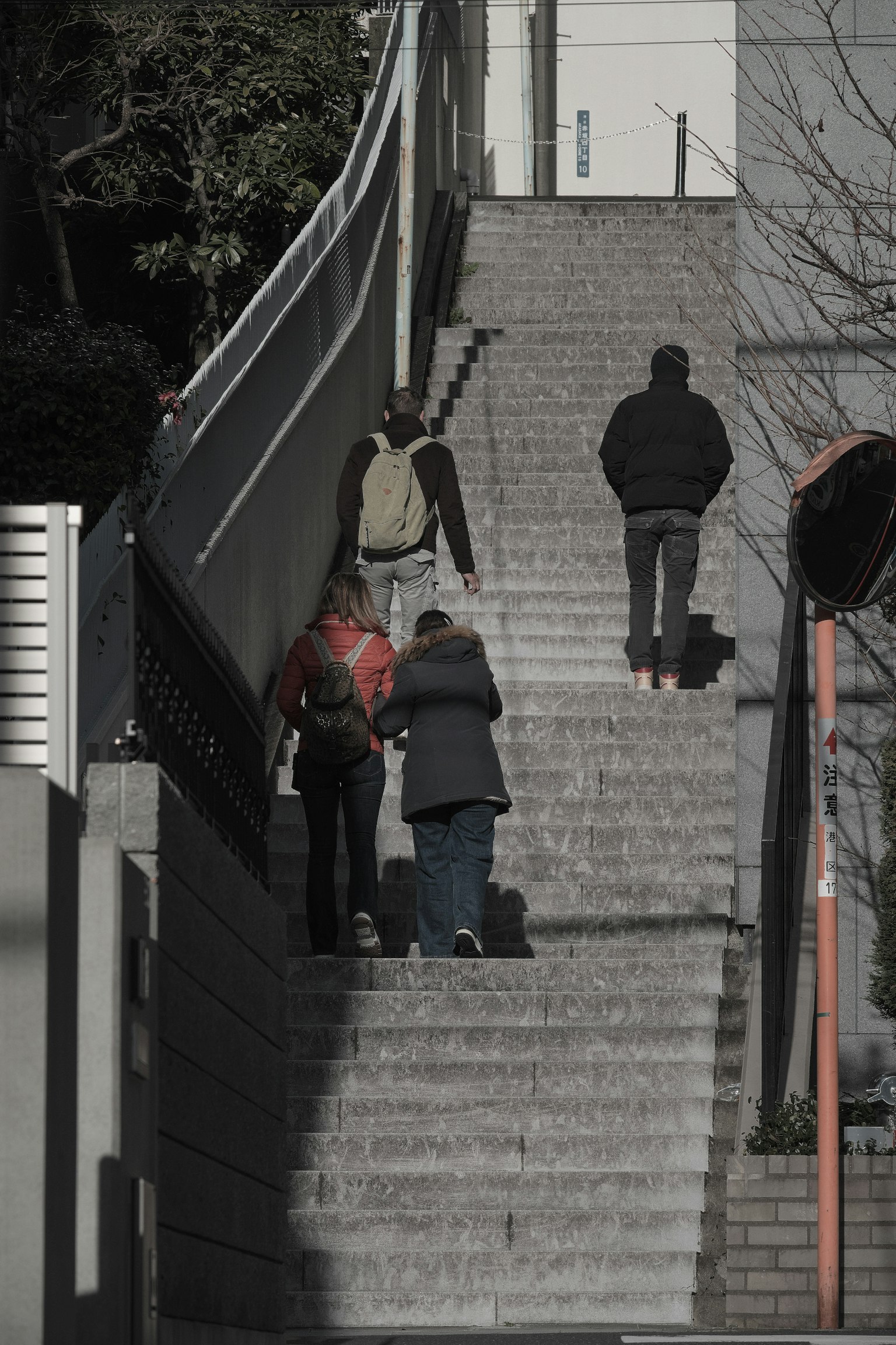 People ascending stairs with surrounding buildings in view