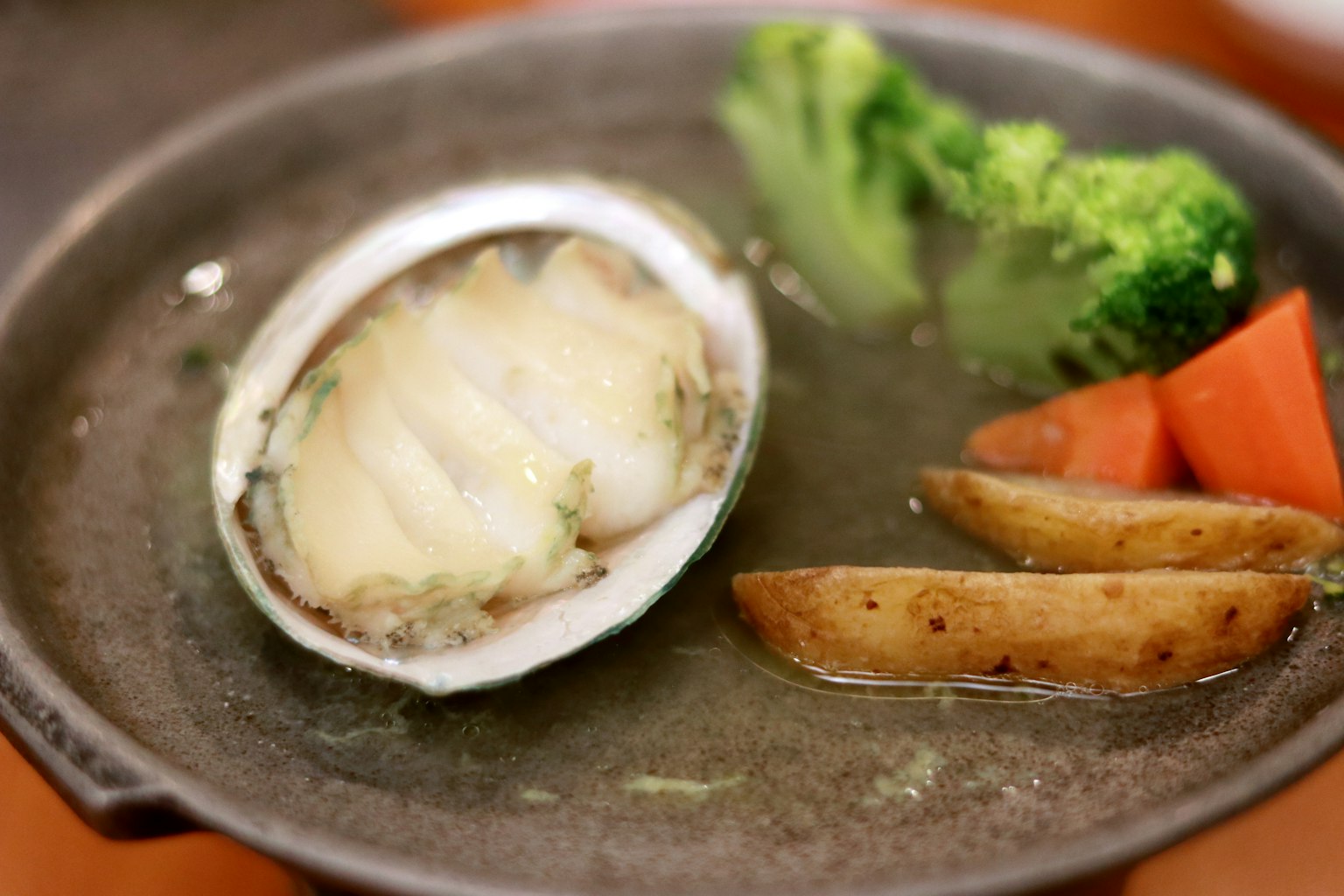 Delicious clam dish with broccoli and carrot sides