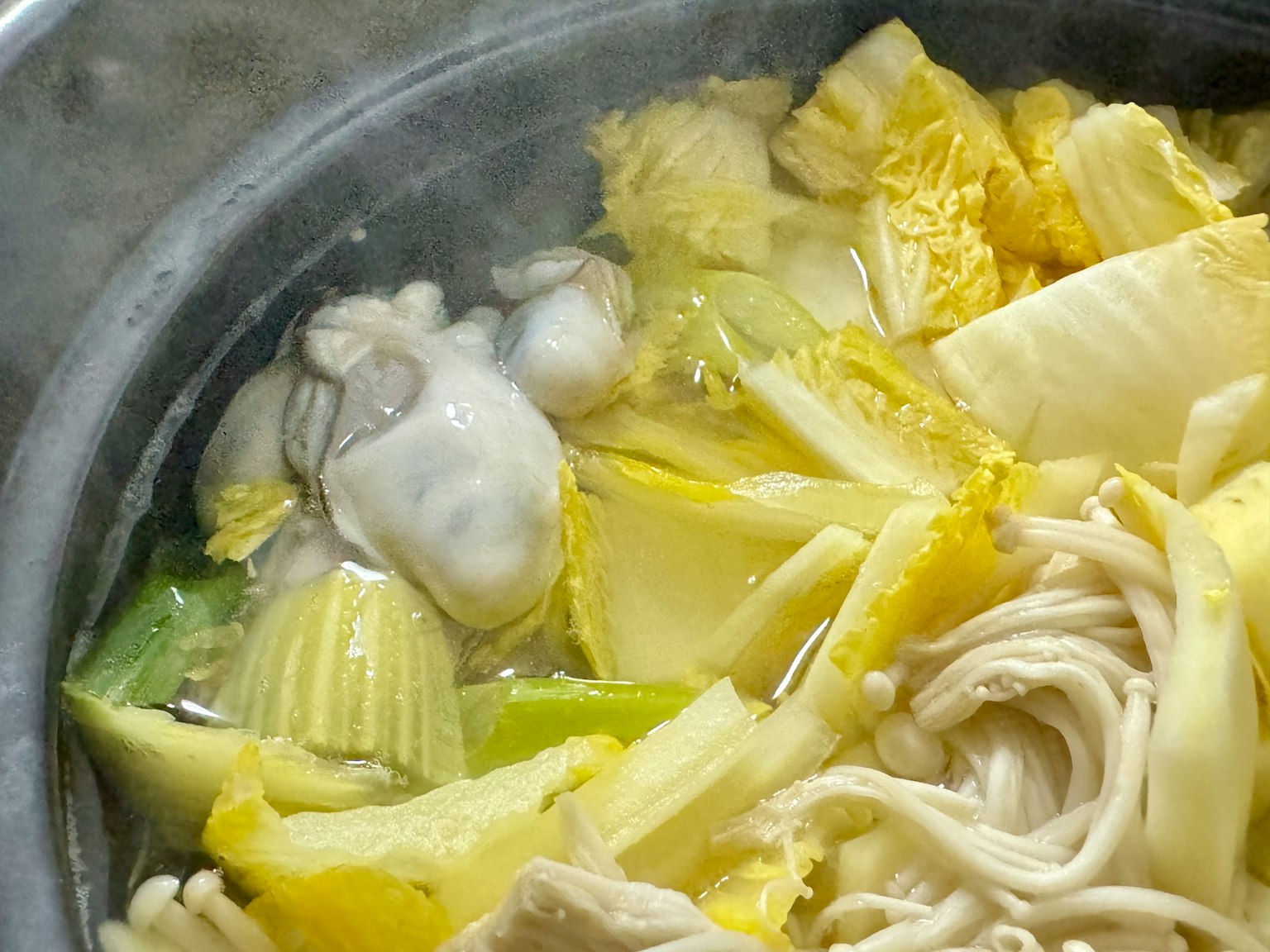 A hot pot dish featuring napa cabbage and mushrooms