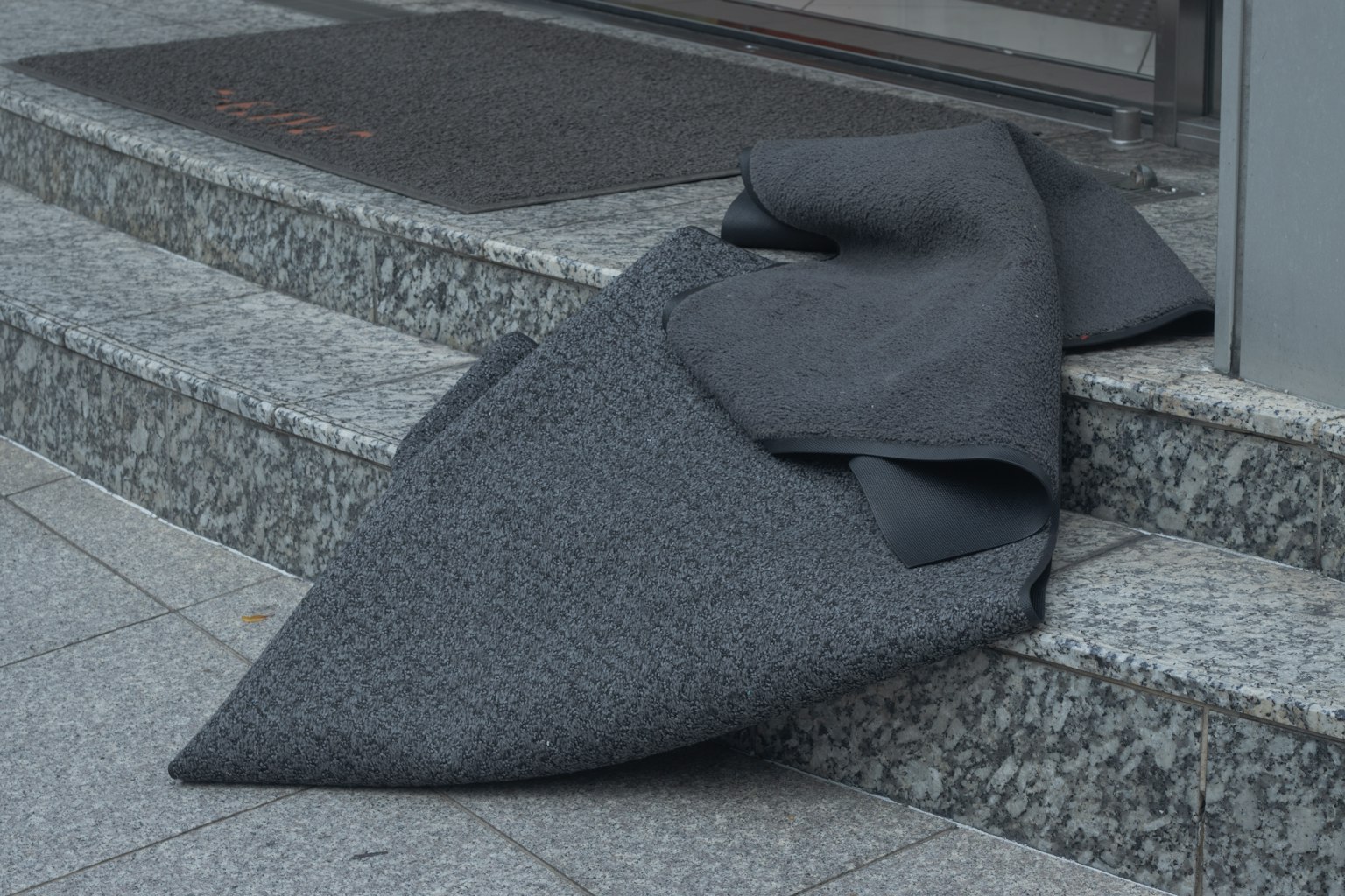 Tela gris caída sobre los escalones en una entrada