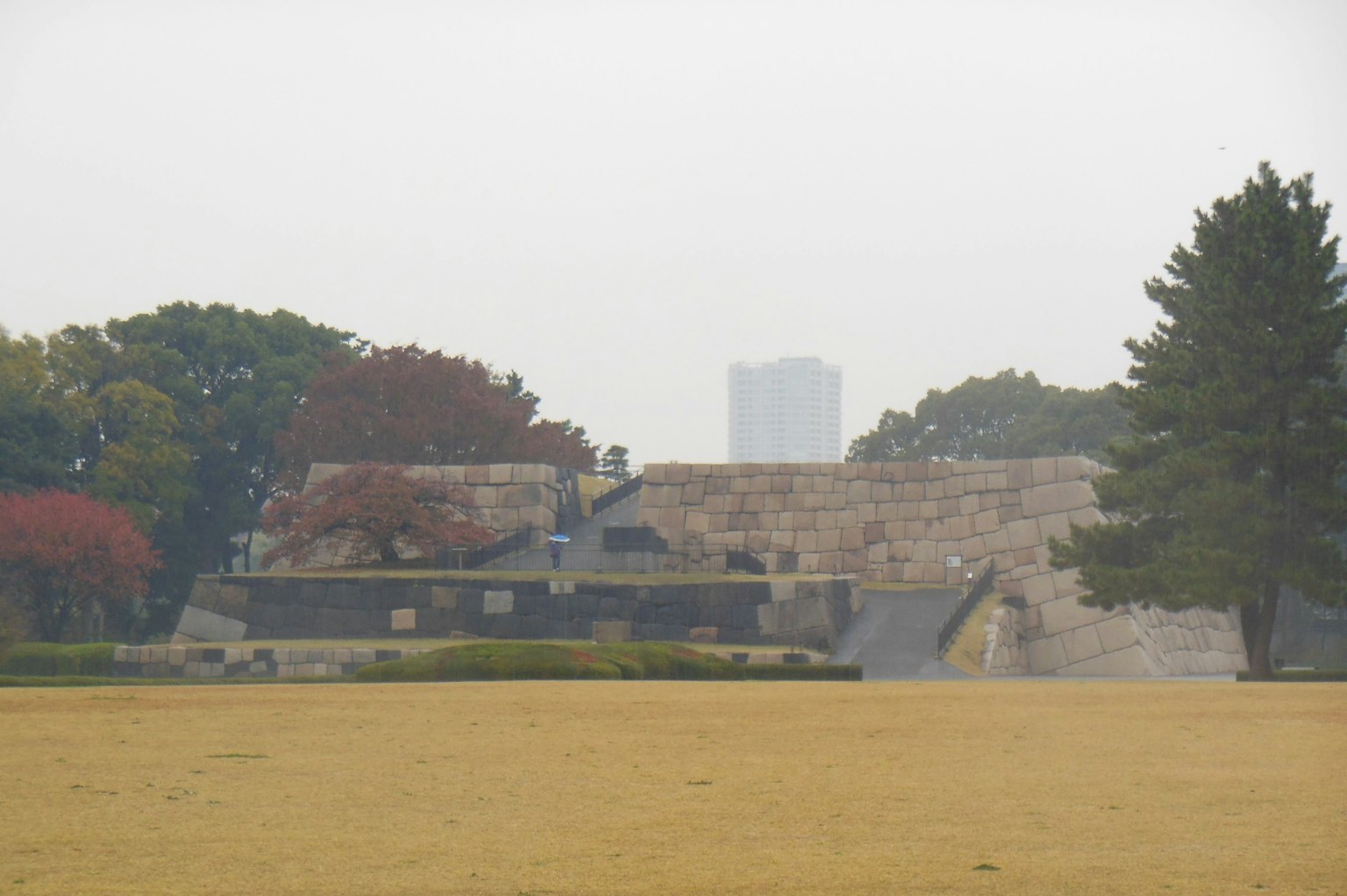 View of a castle ruins and skyscrapers in a park in Tokyo