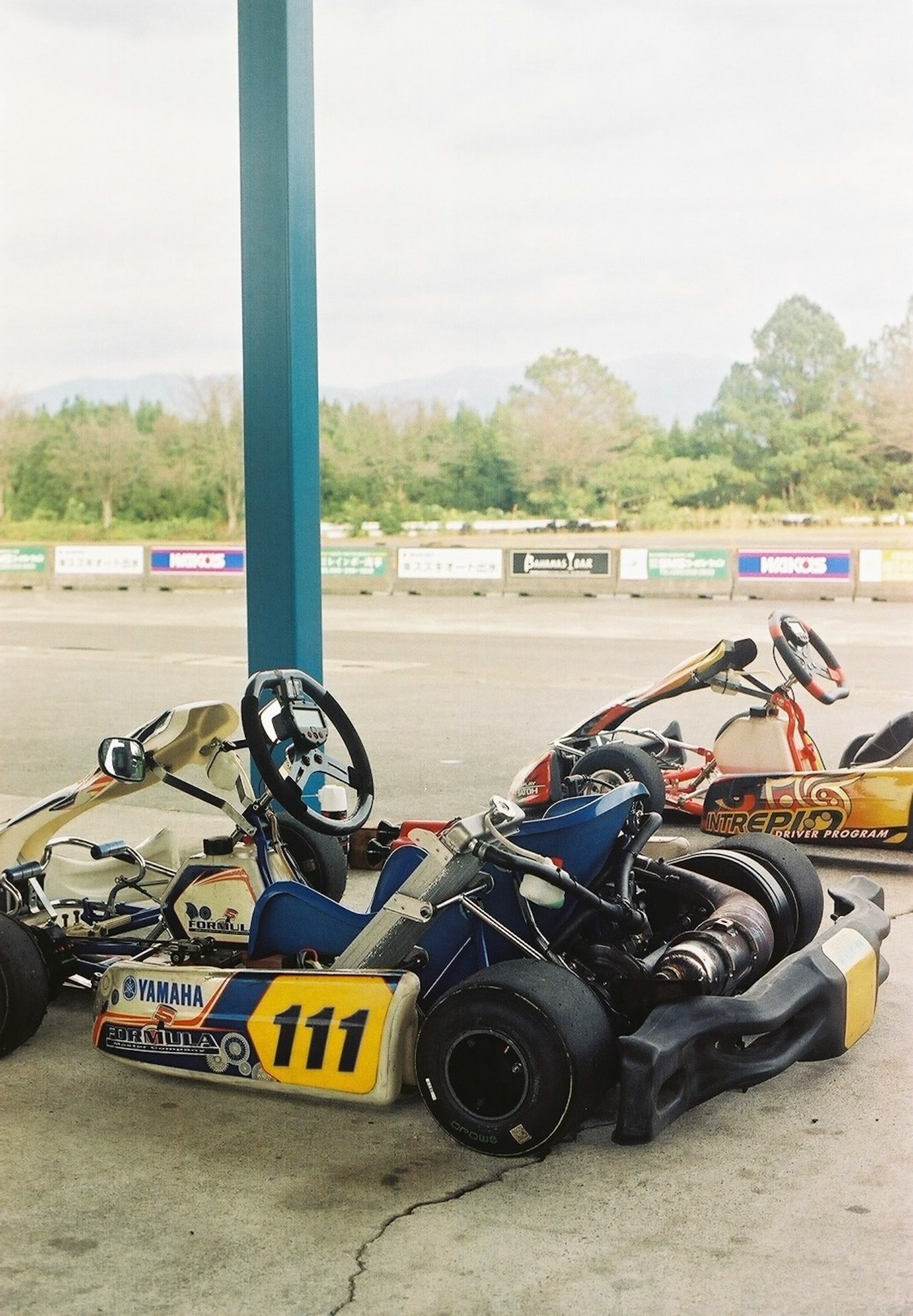 Karts de course garés sous un abri dans une piste de course