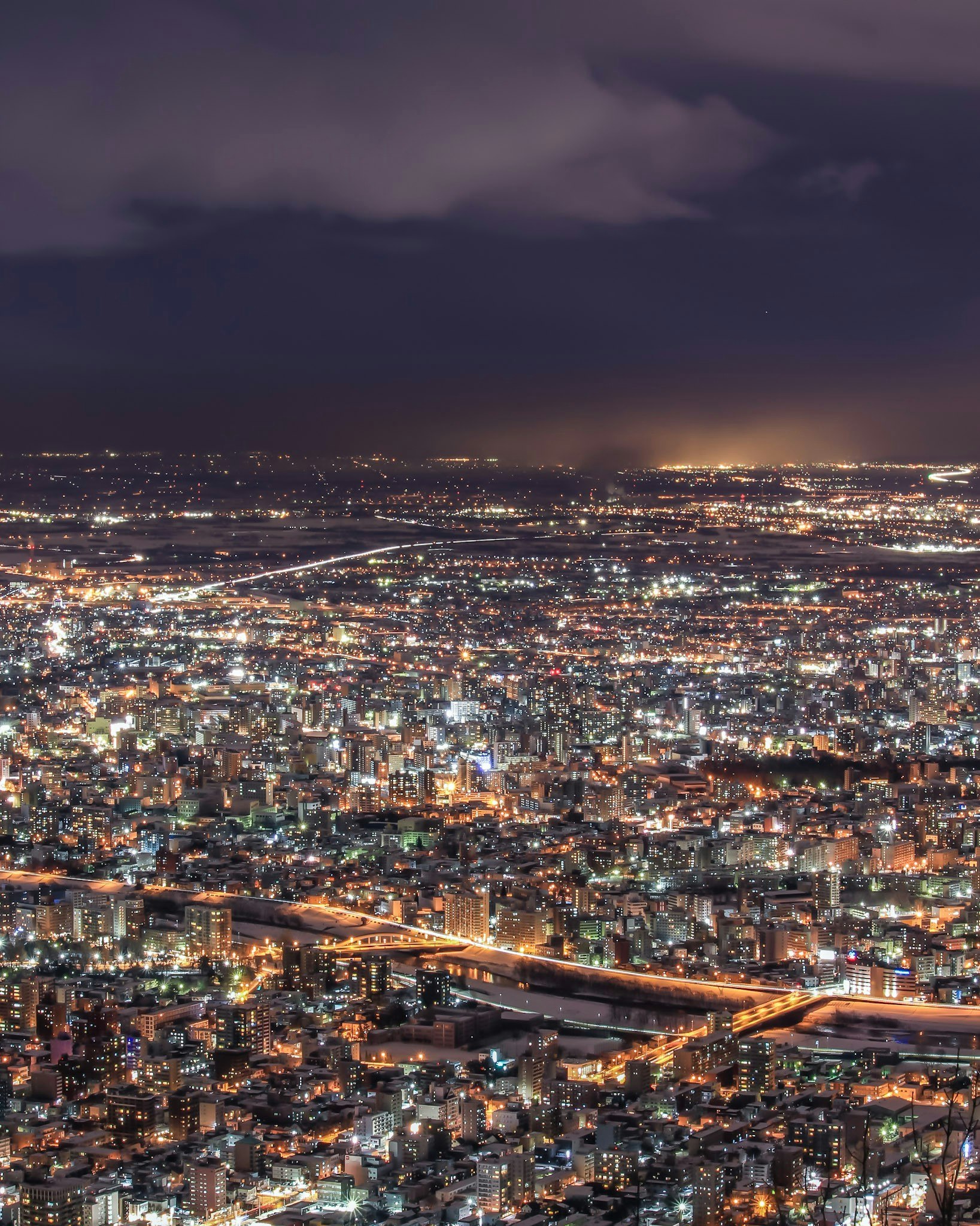 night cityscape view of a bridge over a river