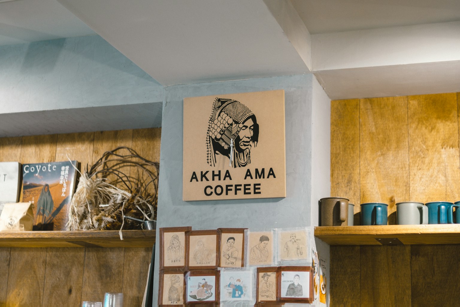 Interior de un café con el letrero Akha Ama Coffee