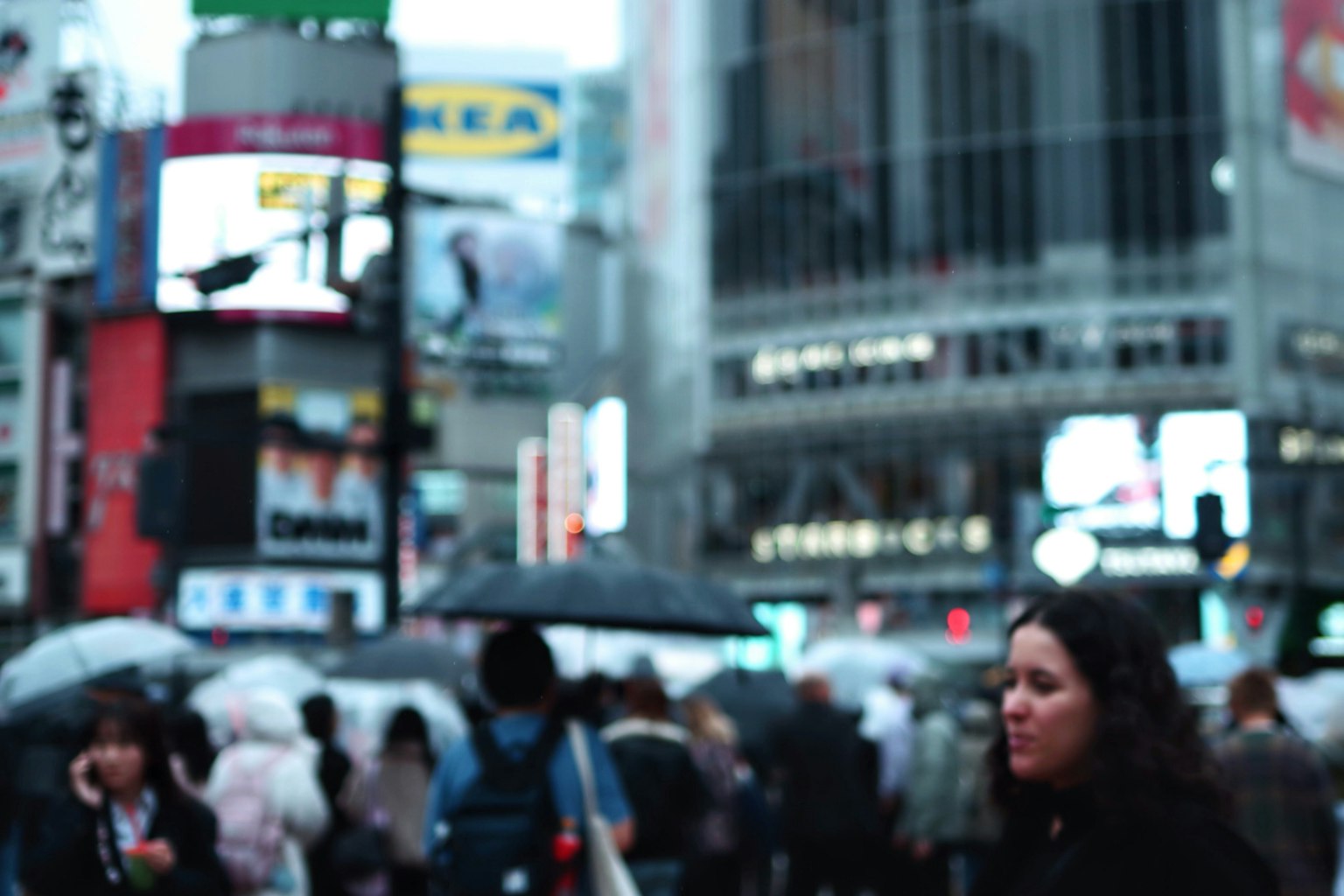 Crowd of people with umbrellas in Shibuya shopping district