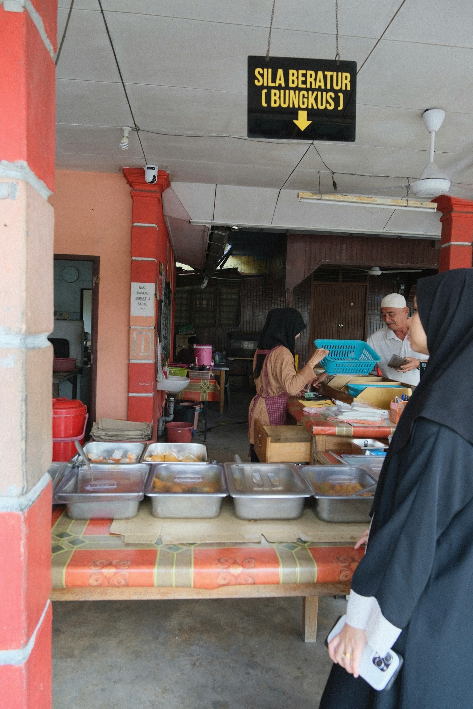 食品攤位展示各種菜餚和用餐的人們