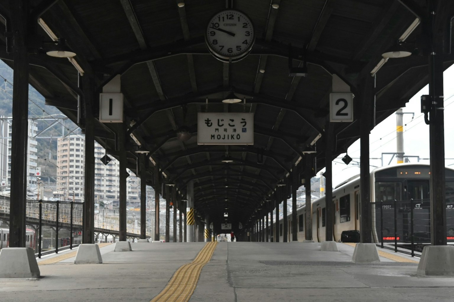 Plateforme de gare avec une horloge et des indicateurs de voie