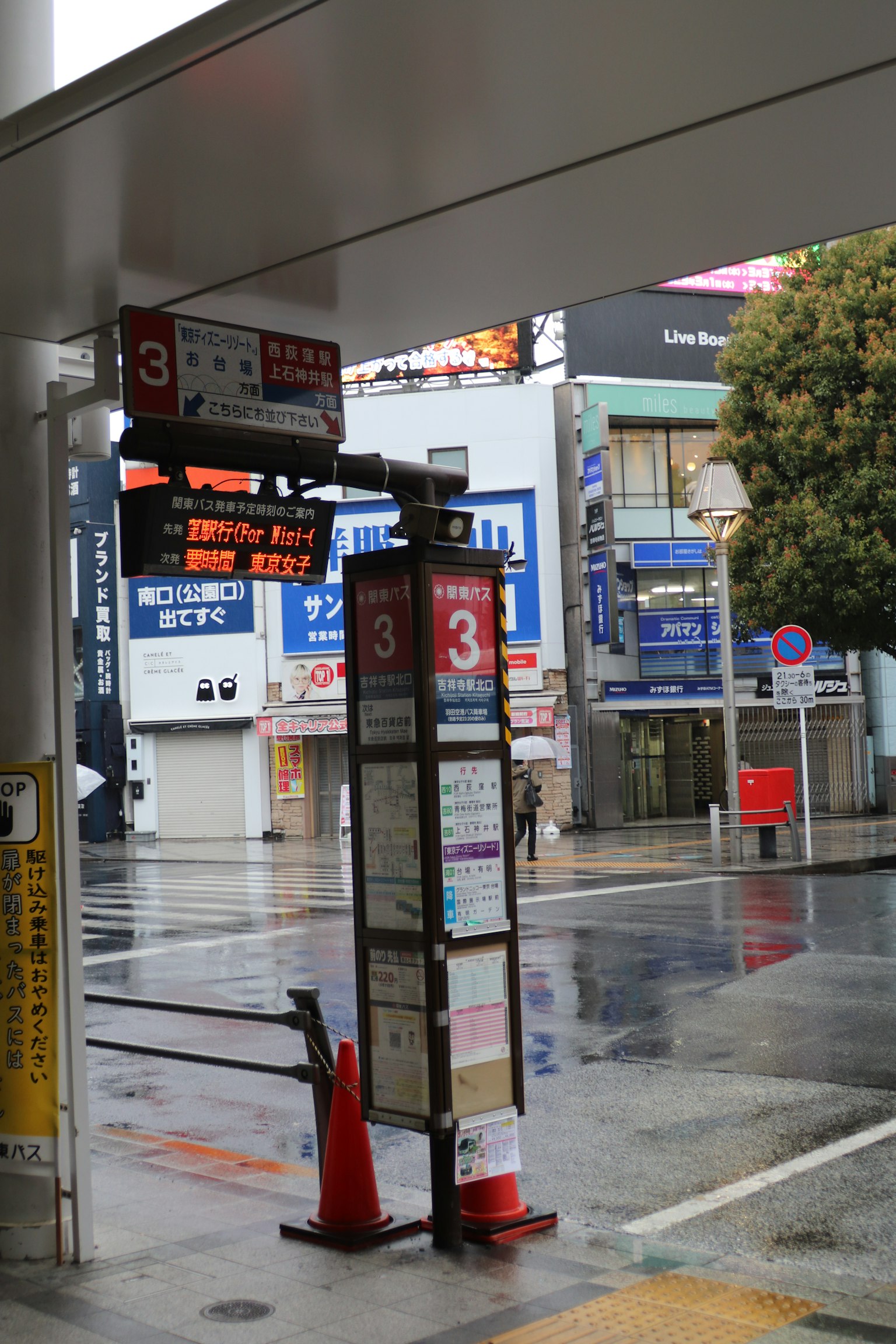 ป้ายรถเมล์หมายเลข 3 ใต้ฝนพร้อมอาคารใกล้เคียง