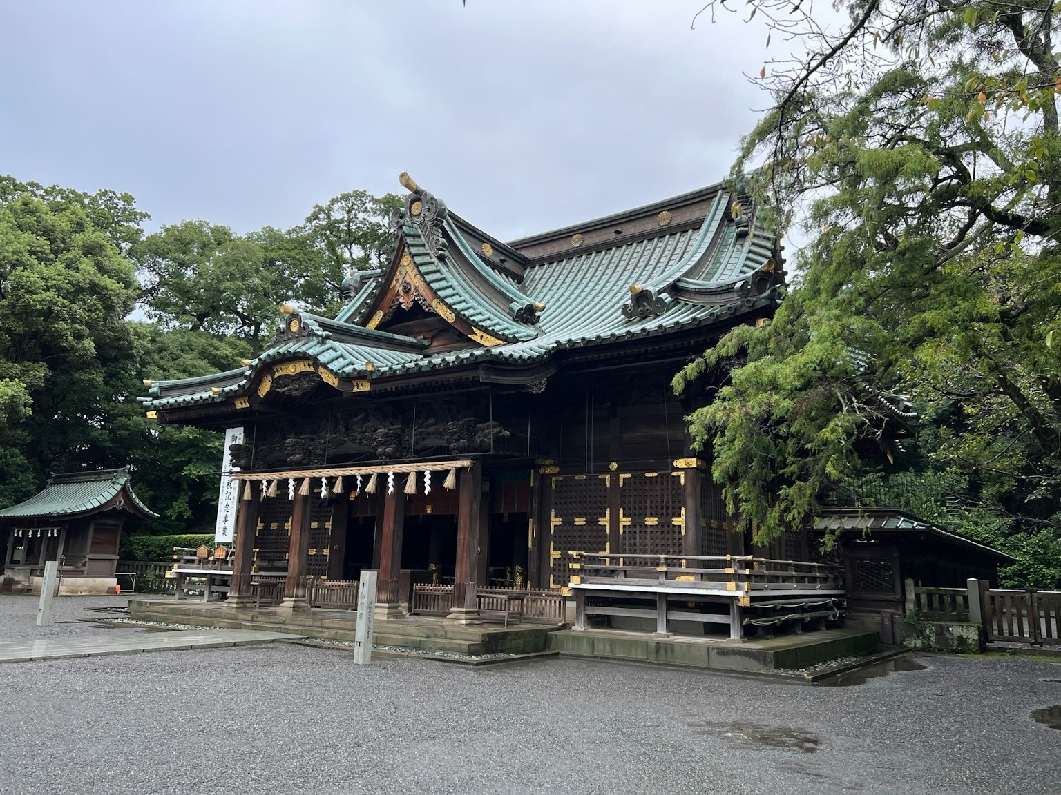 Traditional shrine architecture surrounded by lush greenery