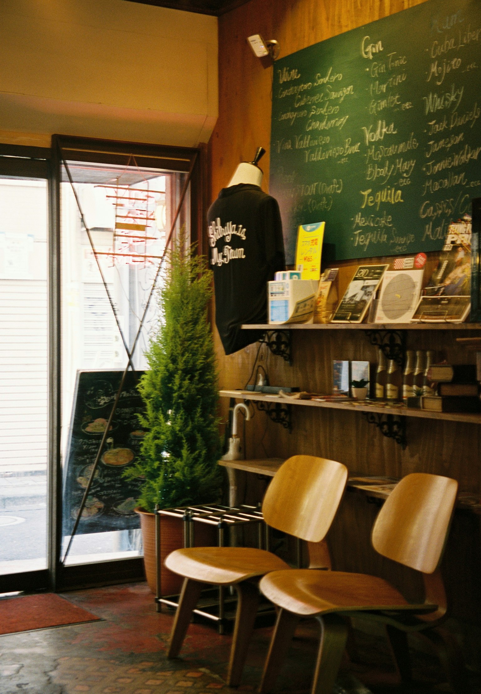 Interior of a café with wooden chairs and a chalkboard