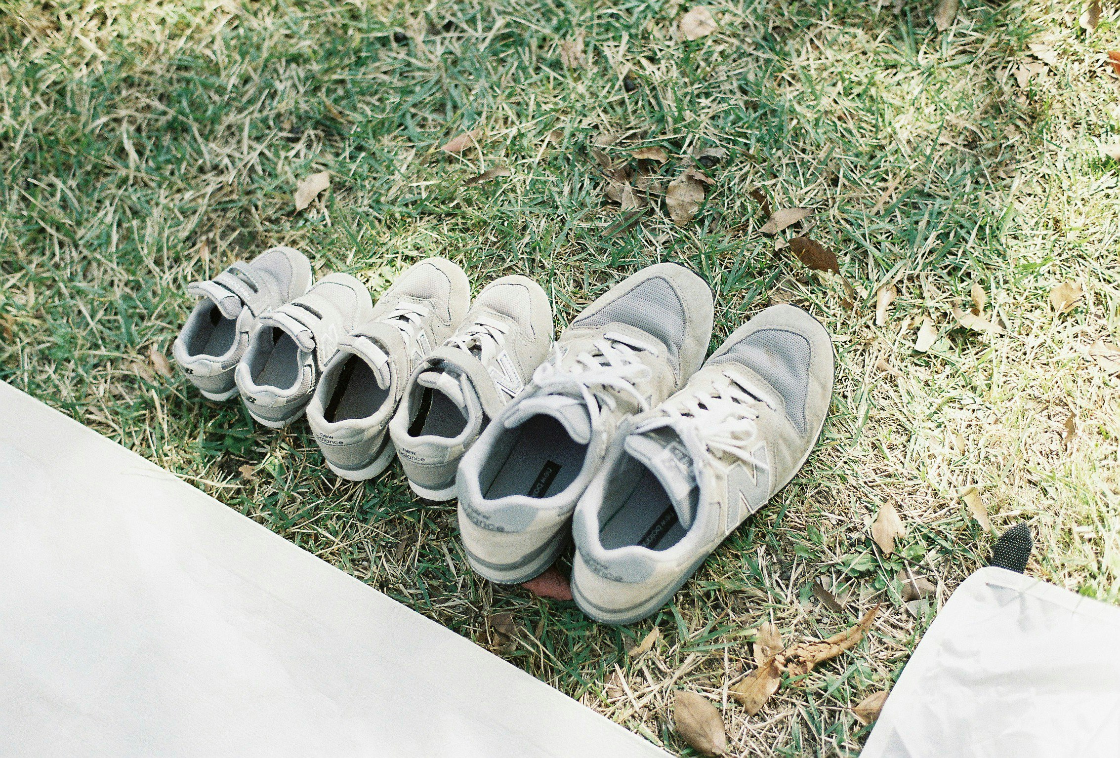 white sneakers lined up on grass