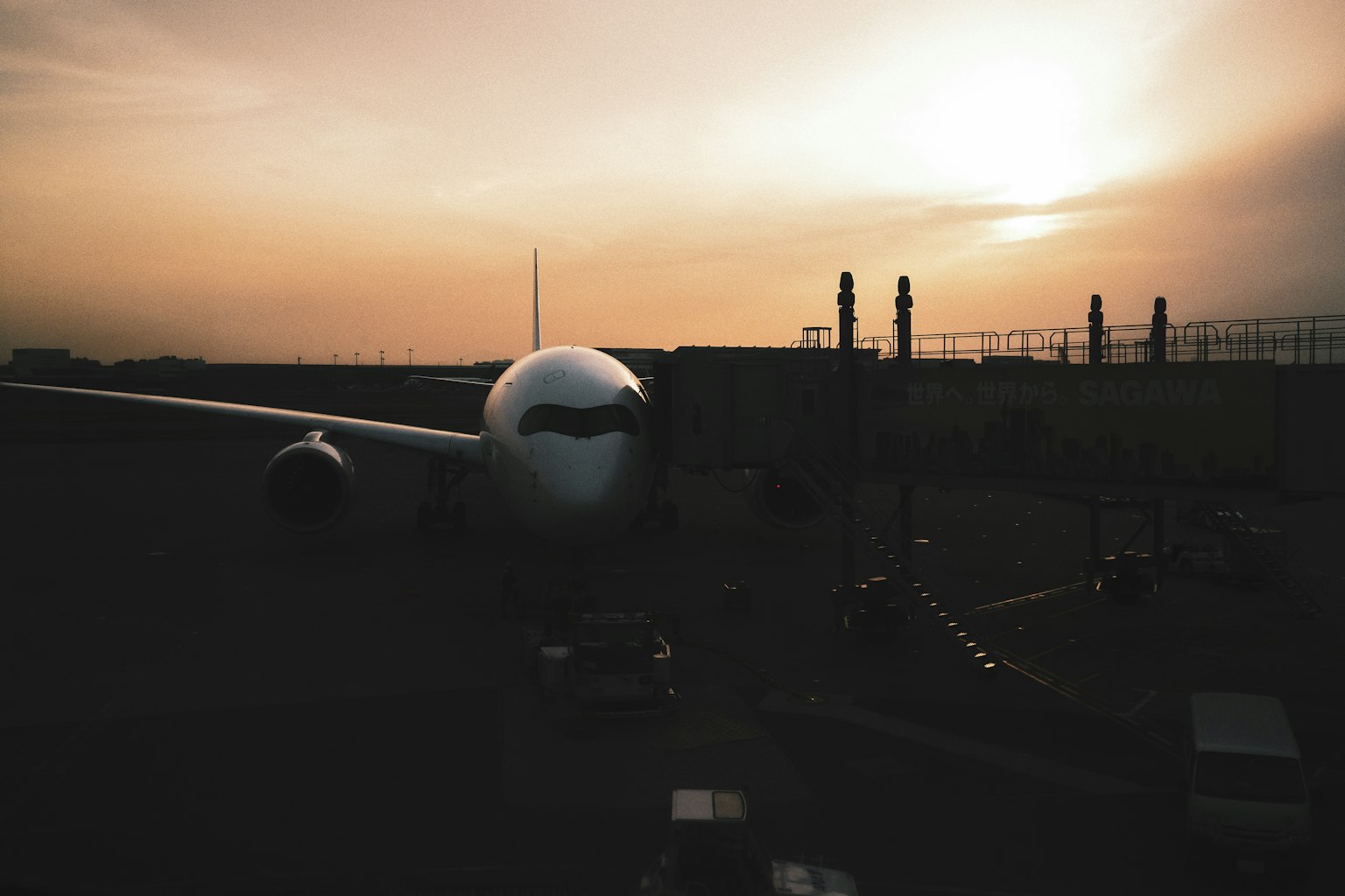 Airplane at sunset in an airport setting