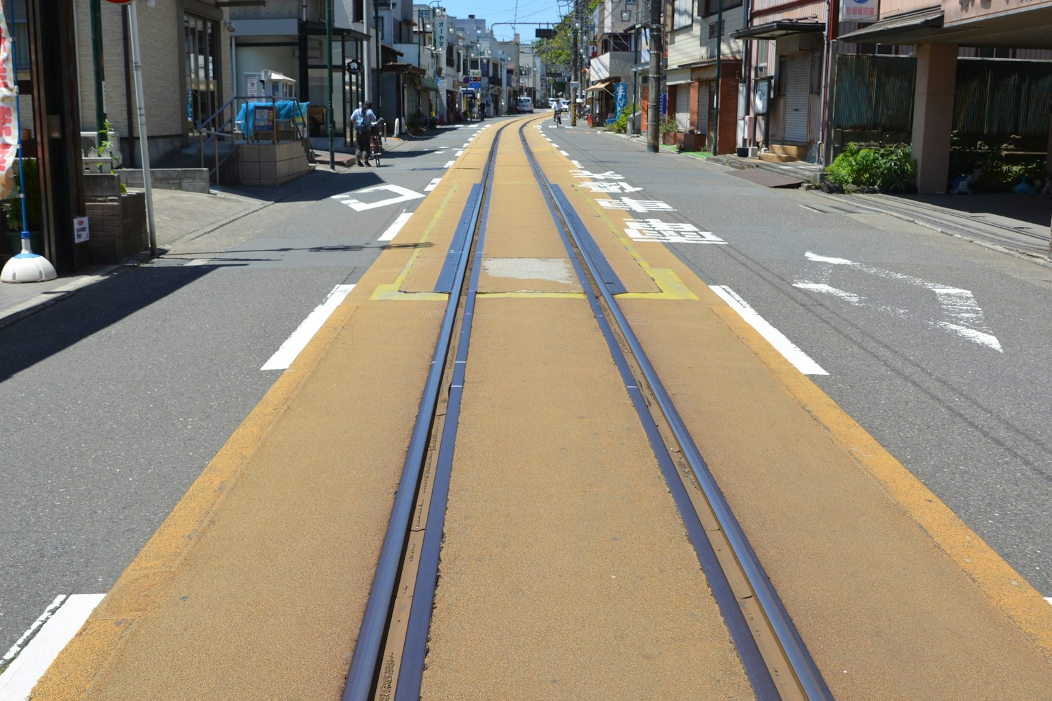 Une rue calme avec des rails de tram jaune