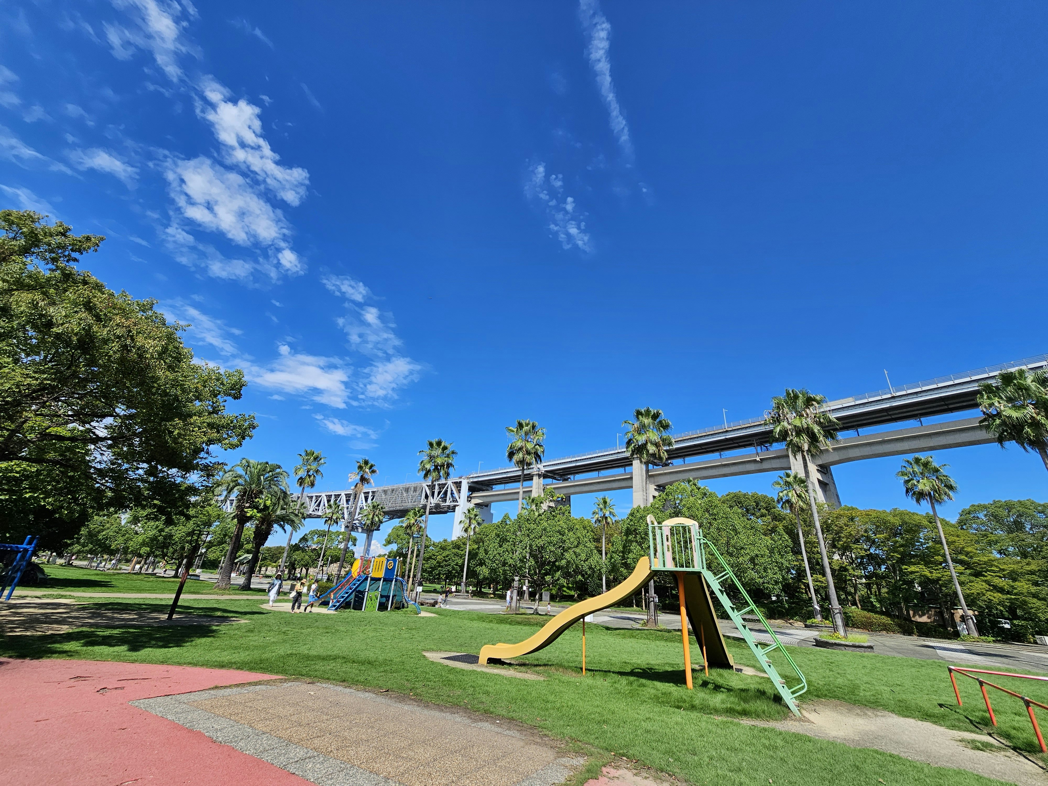 playground equipment and green lawn under a blue sky