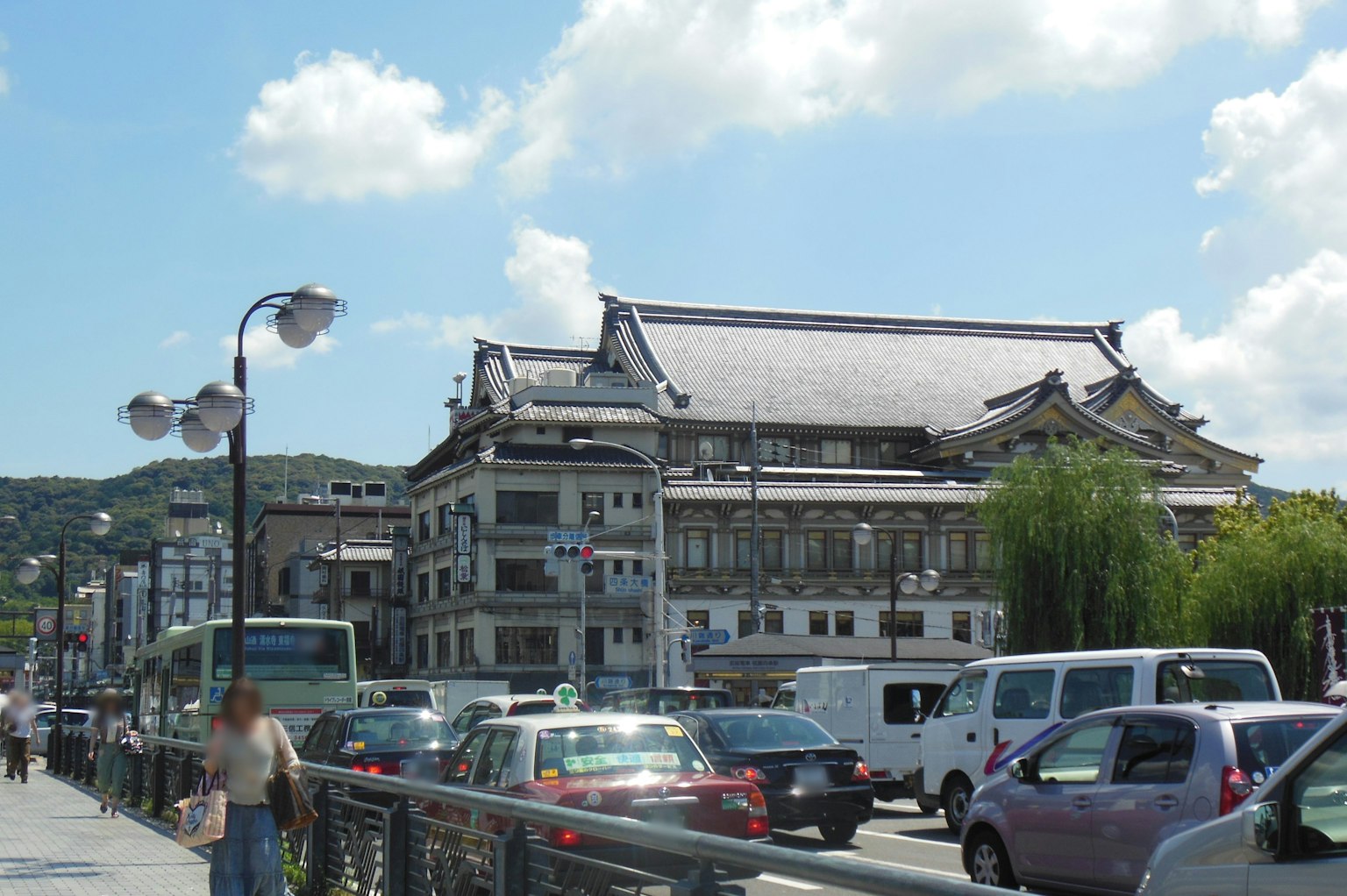 A traditional building alongside a busy street with modern vehicles
