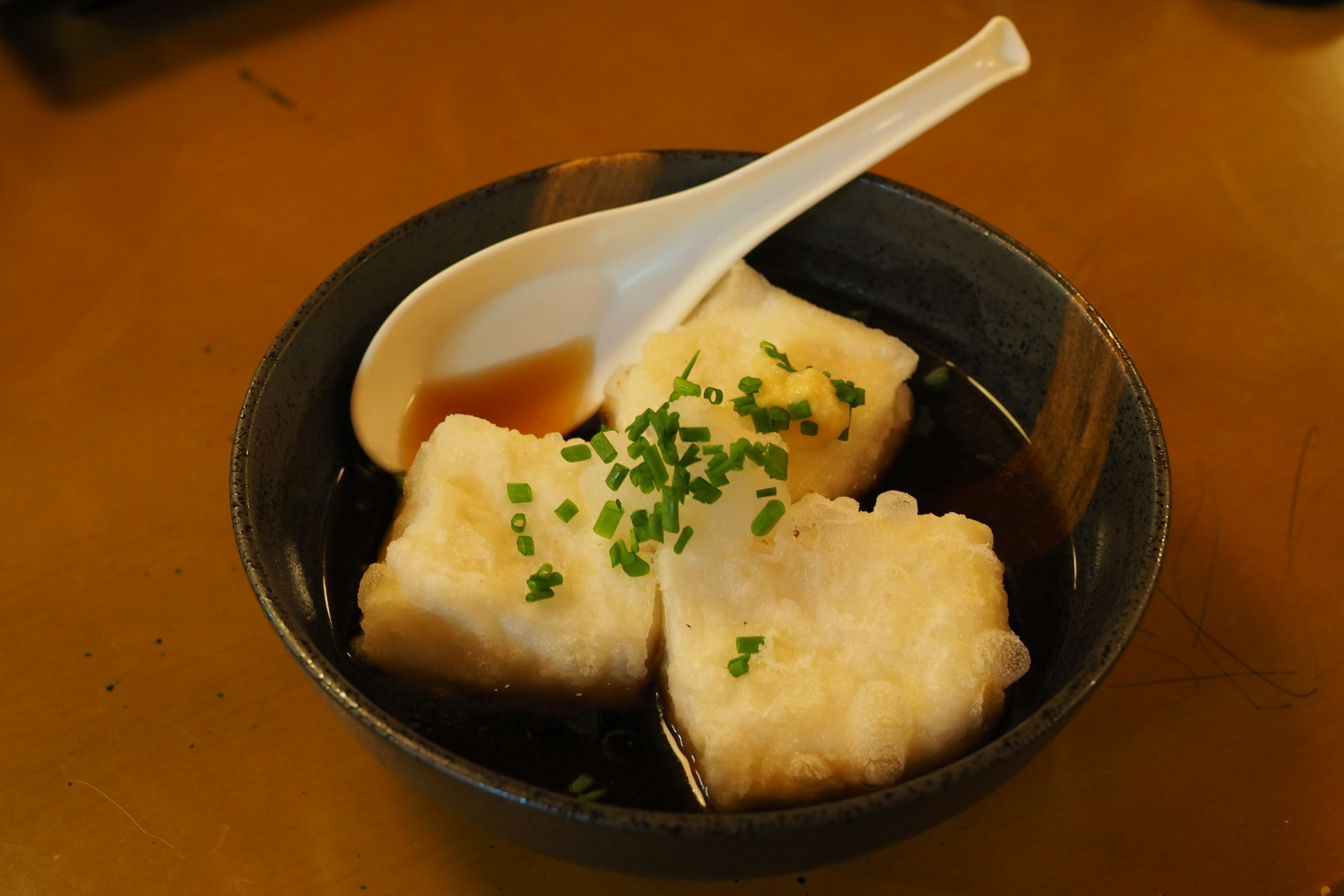 湯碗裡的餃子風味炸物與切碎蔥花