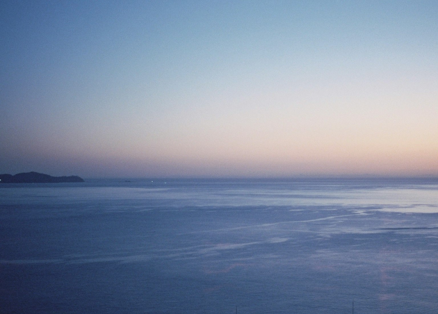 Serene landscape of ocean and sky showcasing beautiful twilight hues