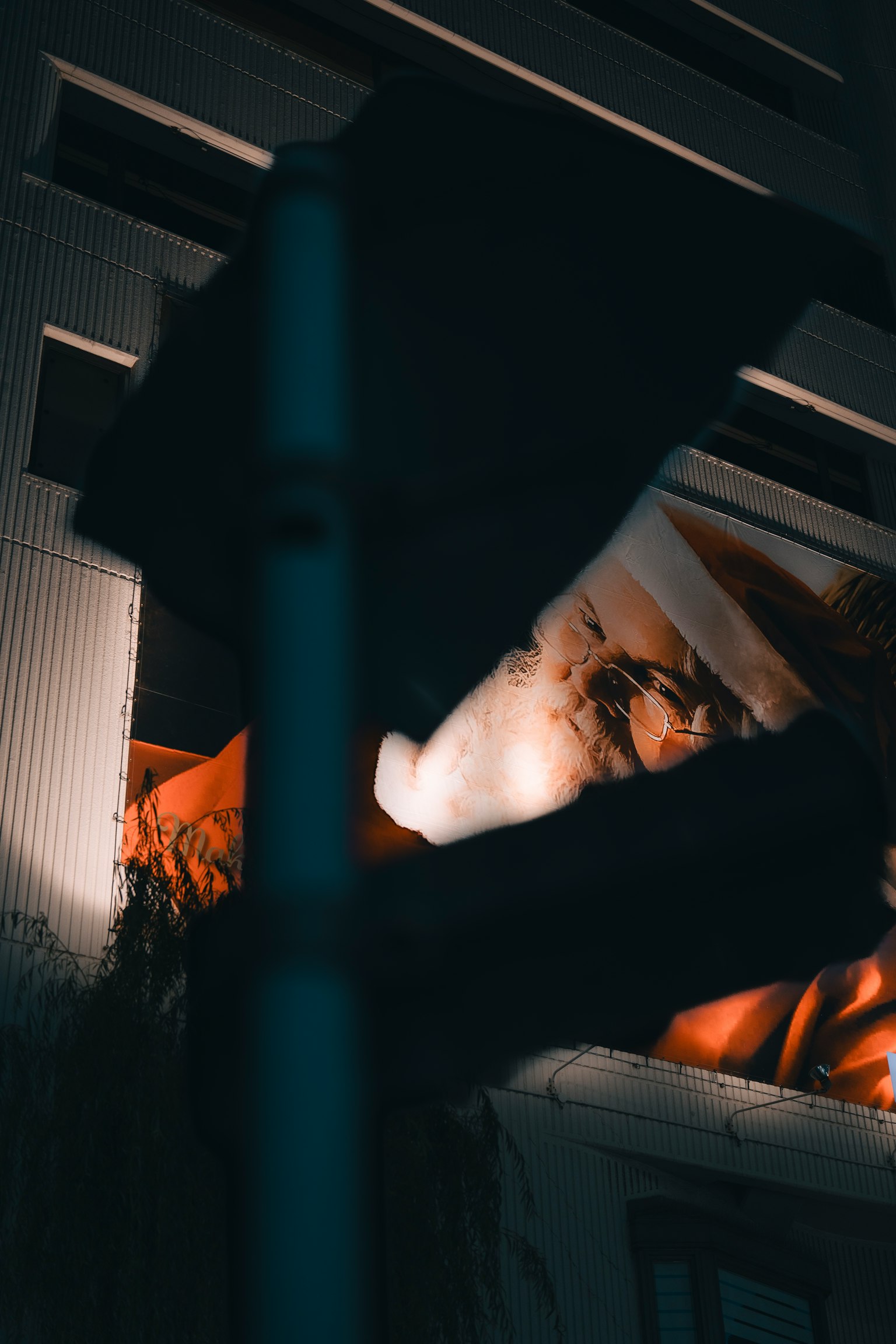 Un personaje con un traje naranja es parcialmente visible contra un fondo oscuro