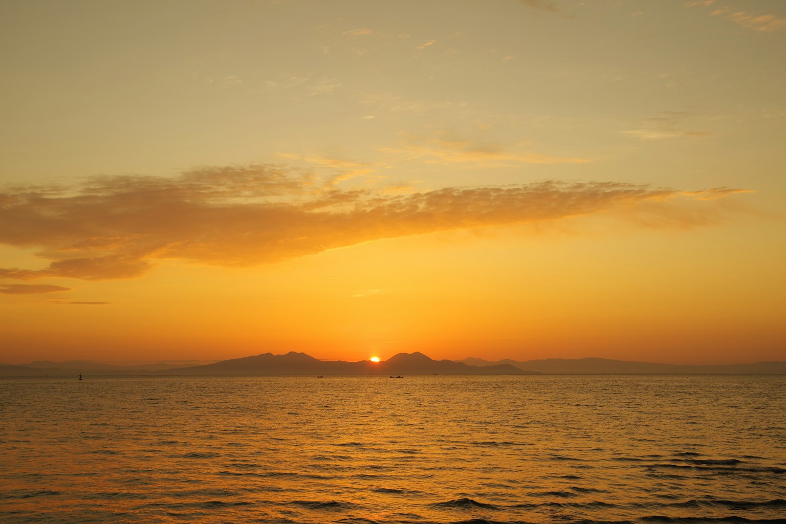 Sunset over the ocean with an orange sky