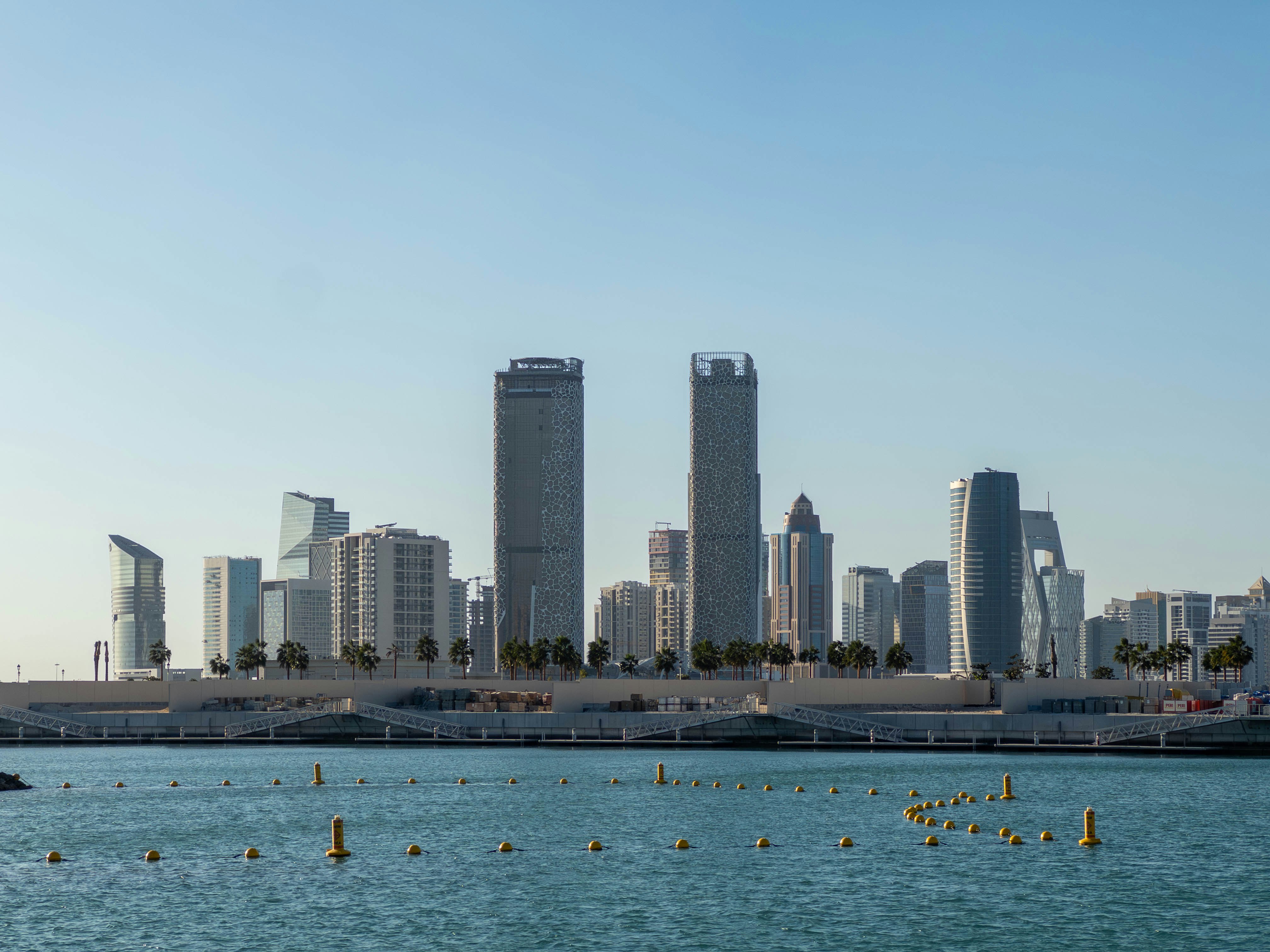 coastal seawall with a skyline of high-rise buildings