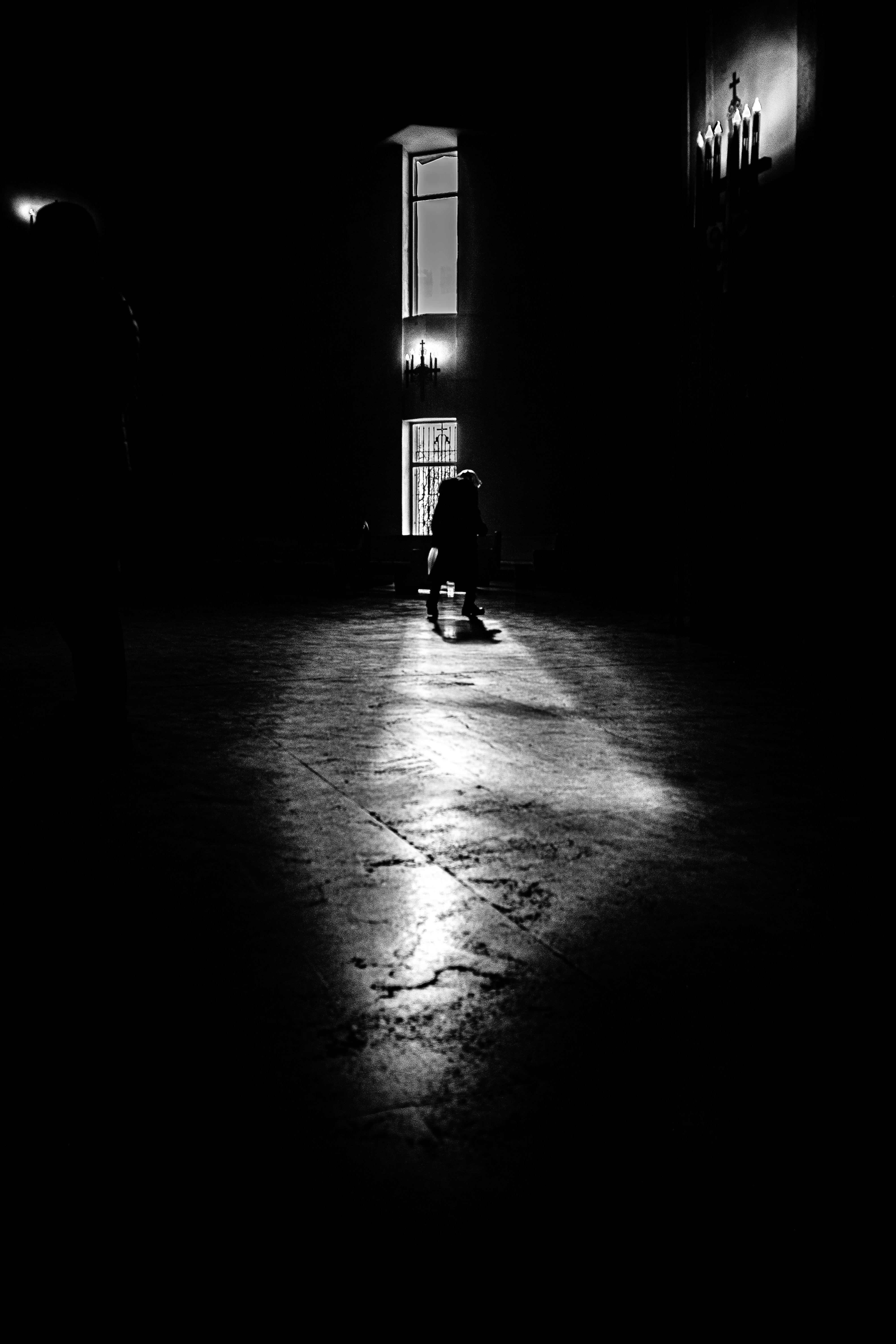 light beams from a streetlamp on a wet alley at night