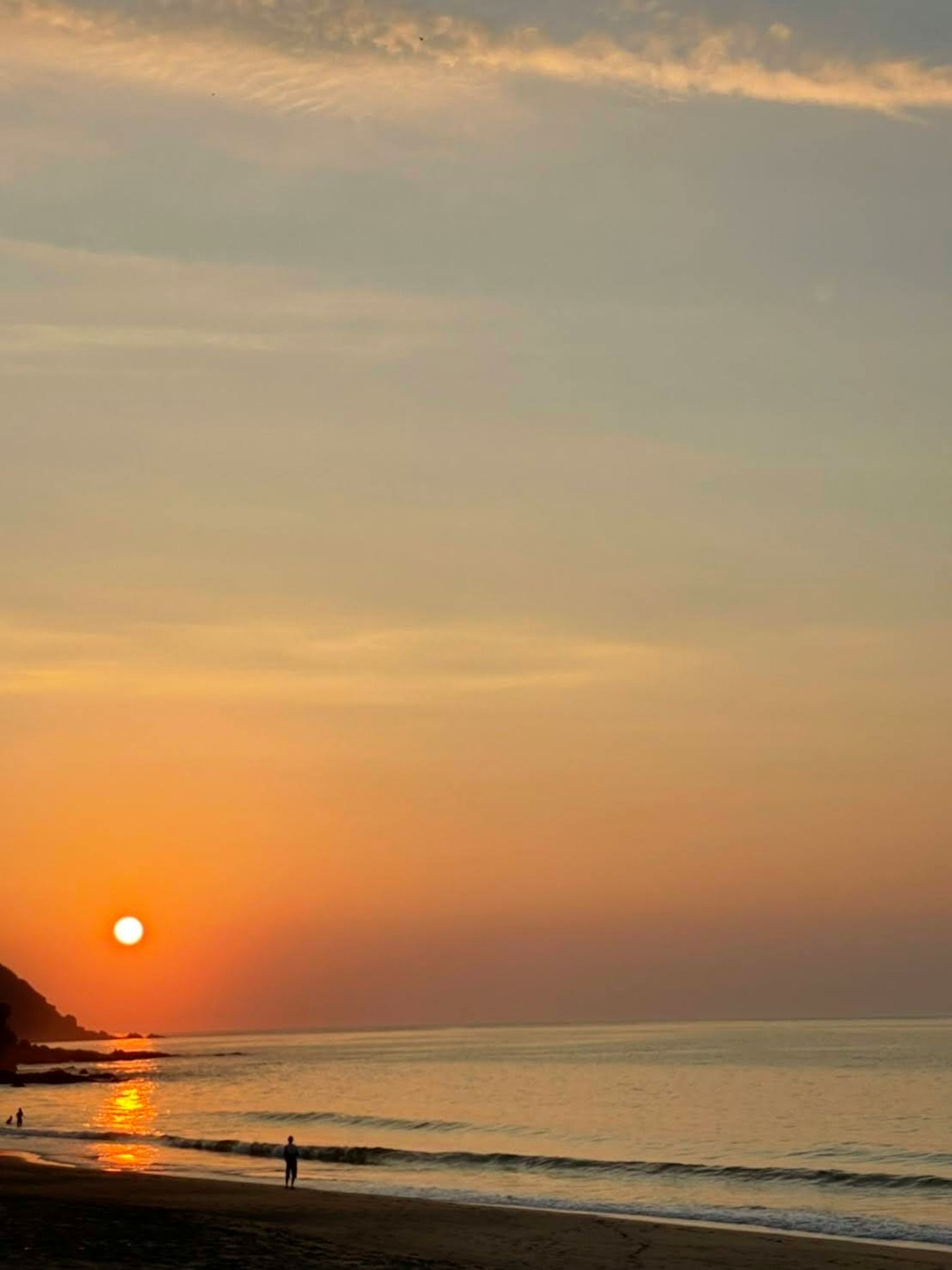 Beautiful beach scene with sunset over the ocean
