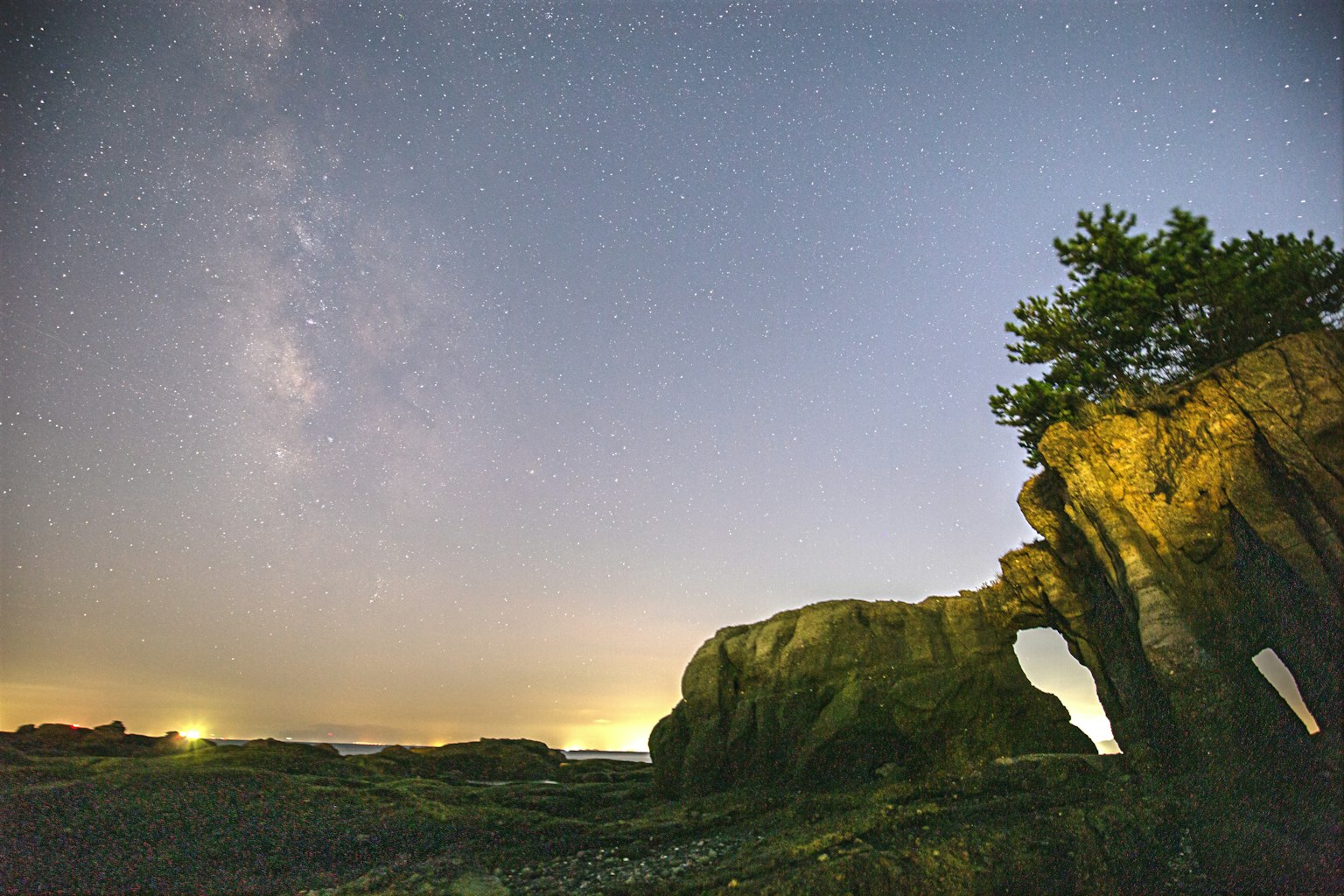 Stunning landscape featuring the Milky Way and a unique rock arch