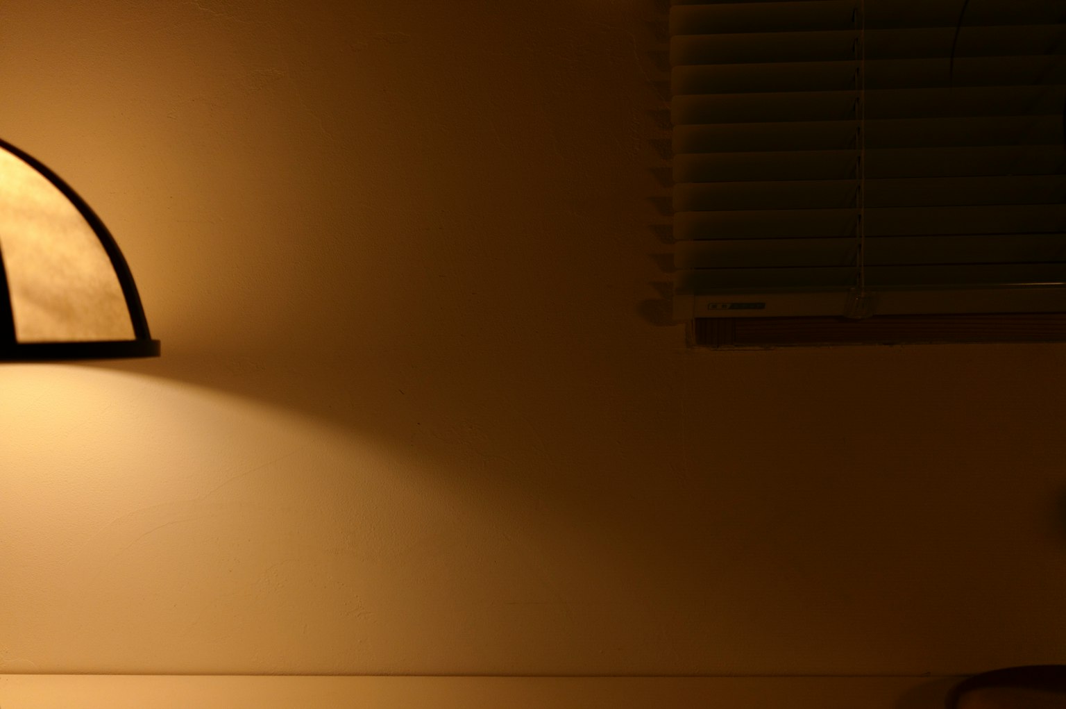 Room with a lamp casting soft light on the wall