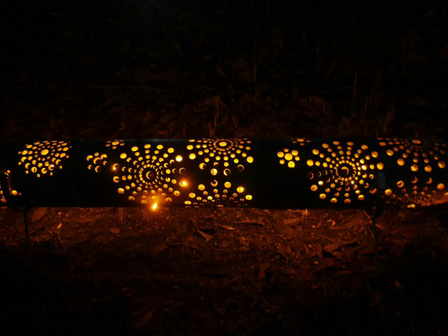 Decorative wooden log with unique hole patterns glowing in the dark