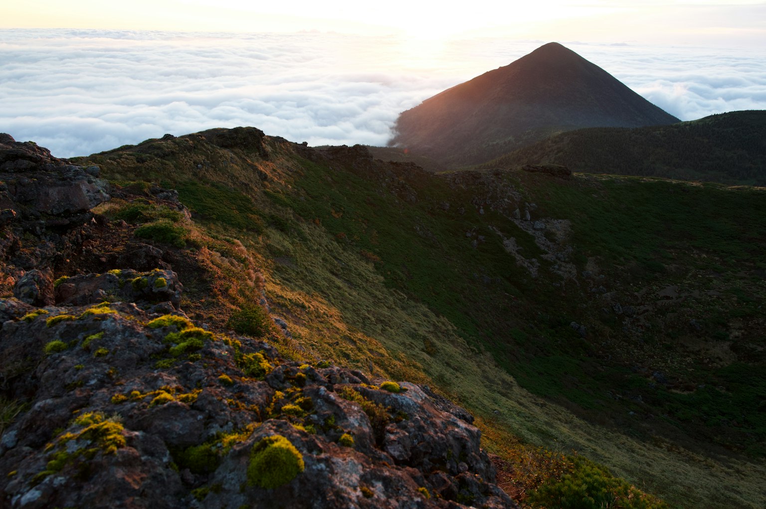 Paesaggio montano con il tramonto sopra le nuvole